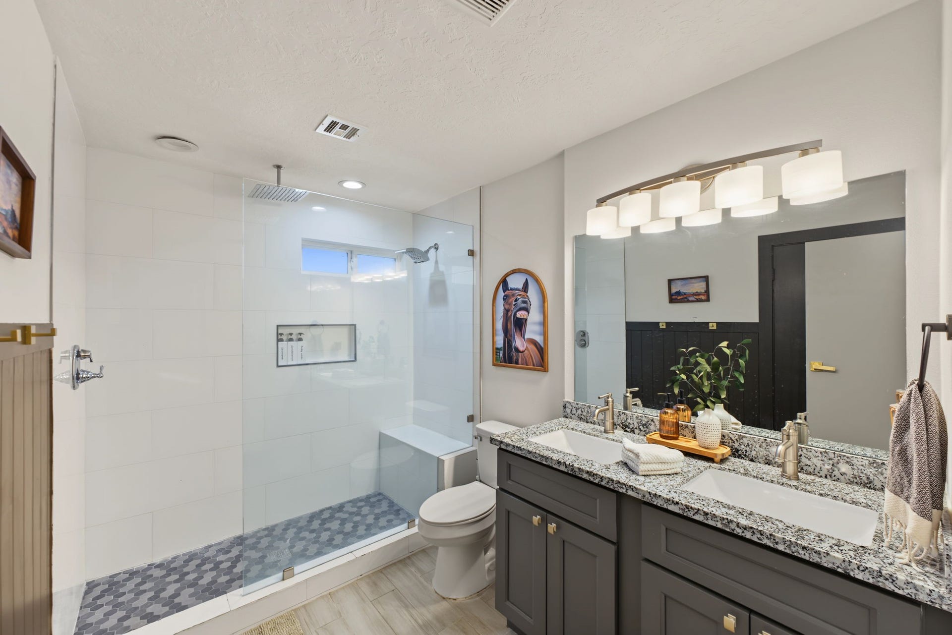5006 Deer Point Drive, Spring, TX 77389 Remodeled bath boasts a walk-in shower with frameless glass, rain head, hex mosaic floor, built-in bench and niche, plus a granite double vanity!