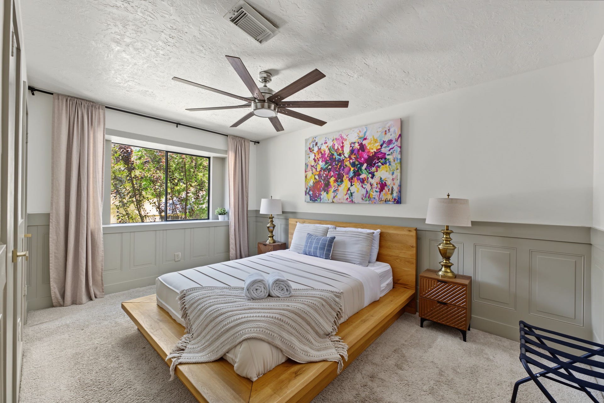 5006 Deer Point Drive, Spring, TX 77389 Secondary bedroom #2 features plush carpet, raised-panel wainscoting and an oversized ceiling fan.
