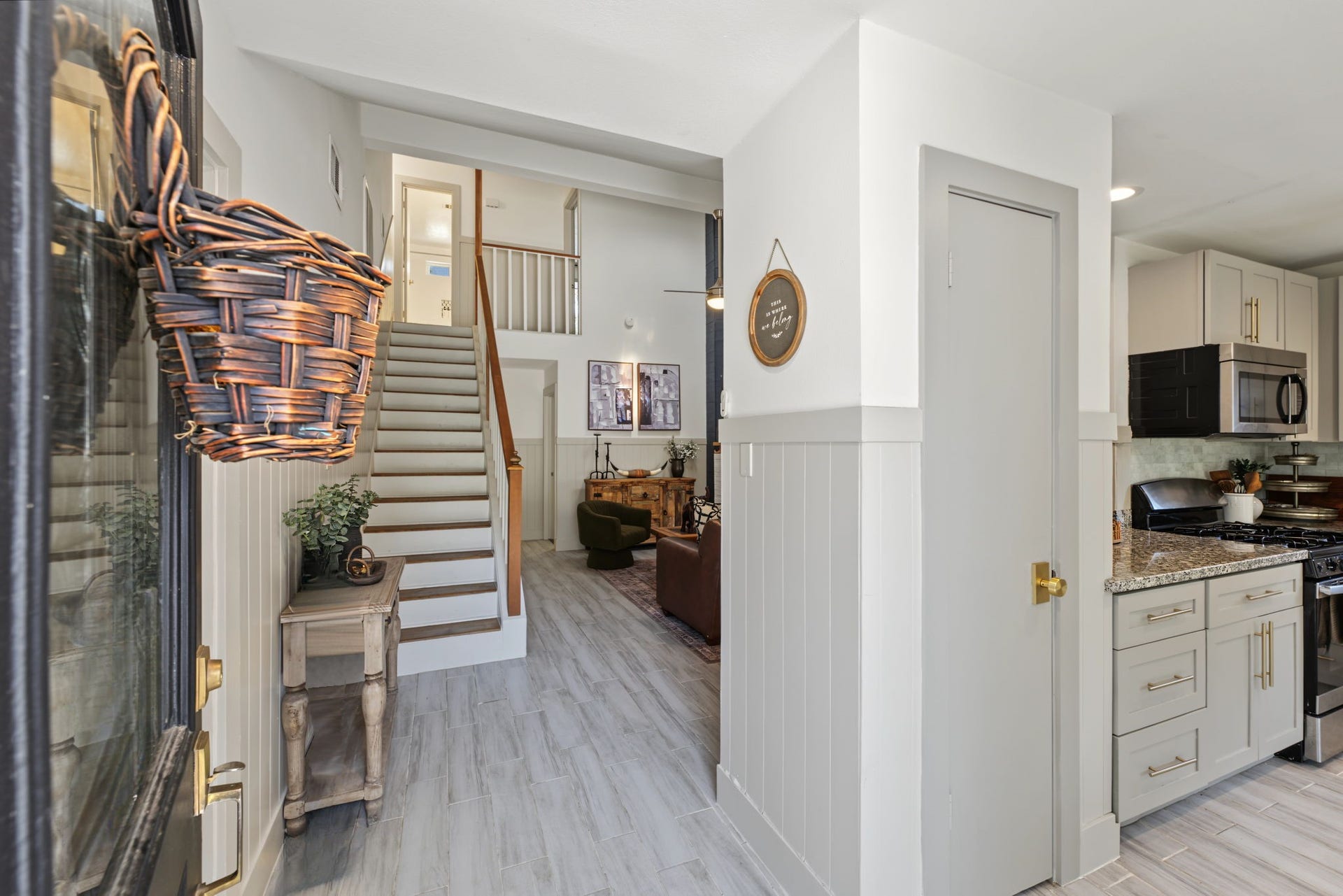 5006 Deer Point Drive, Spring, TX 77389 Entry opens to wood-look tile flooring, shiplap wainscoting and a peek into the kitchen.