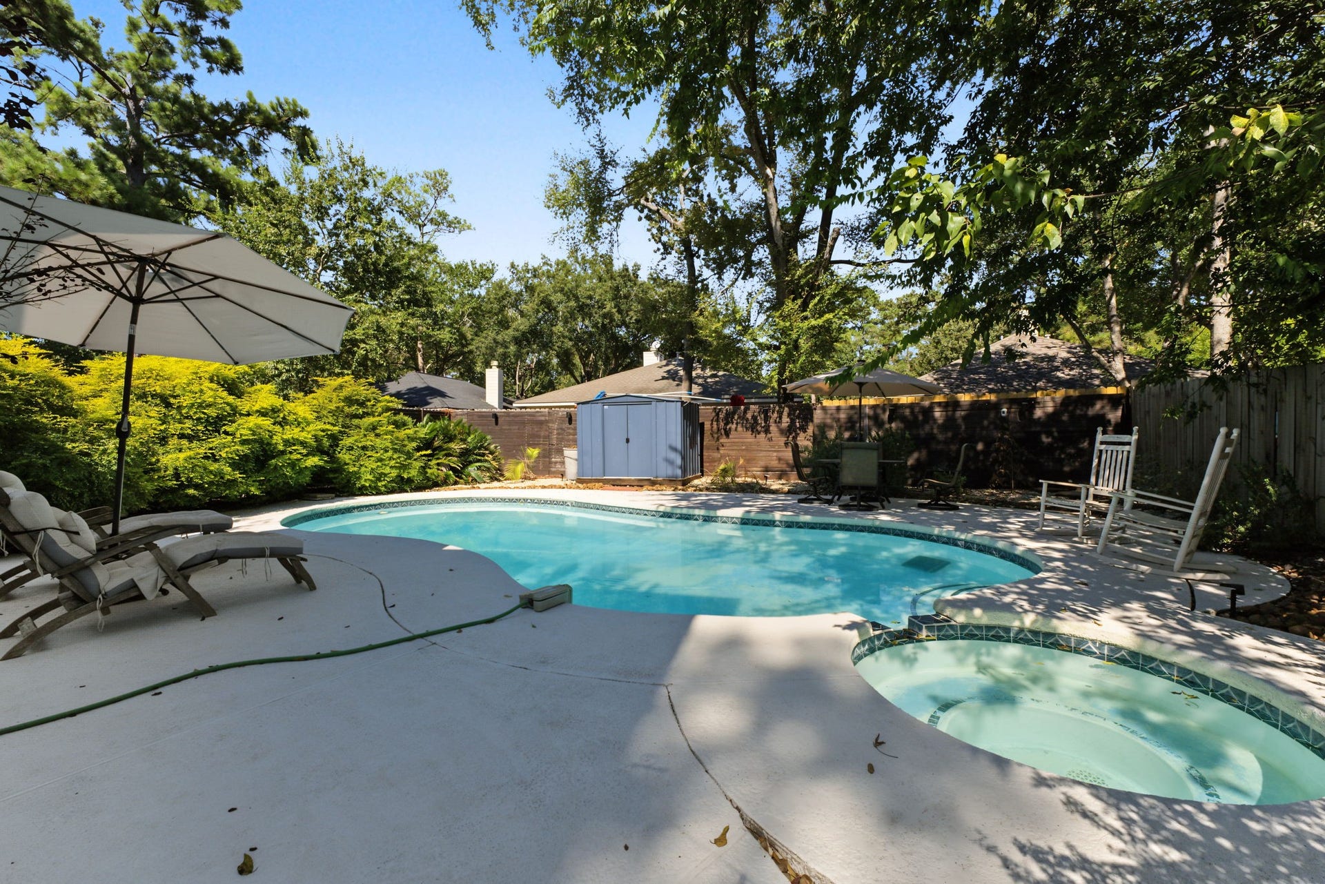 5006 Deer Point Drive, Spring, TX 77389 Sparkling pool with plenty of room to lounge under mature shade trees, plus a storage shed for pool gear!