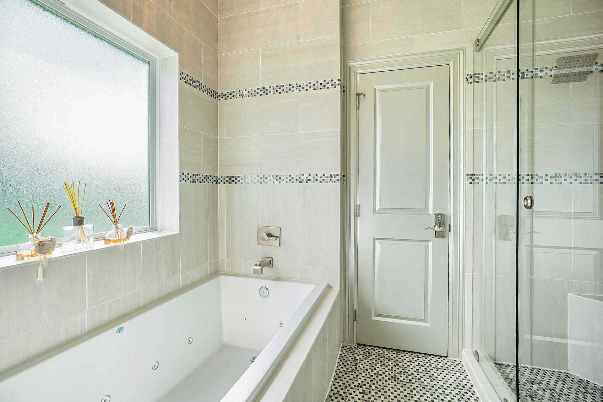 1171 Sailfish Street, Bayou Vista, TX 77563 Experience luxury in this elegant bathroom featuring a spacious soaking tub, sleek glass-enclosed shower, and stylish tile accents.