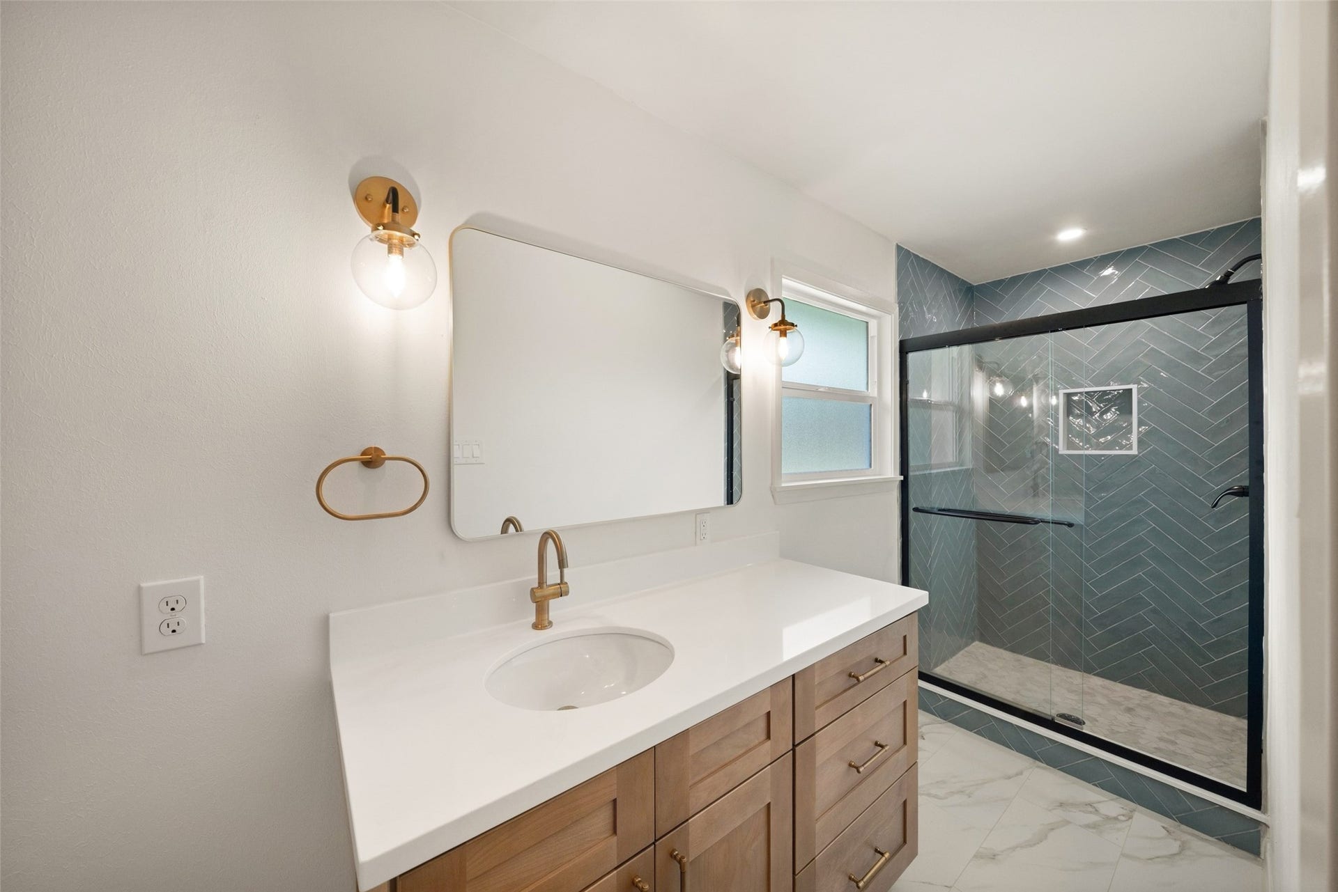 4806 Hummingbird Street, Houston, TX 77035 Elegant bathroom featuring a modern vanity with sleek fixtures, ambient lighting, and a spacious glass-enclosed shower with stylish tile work.