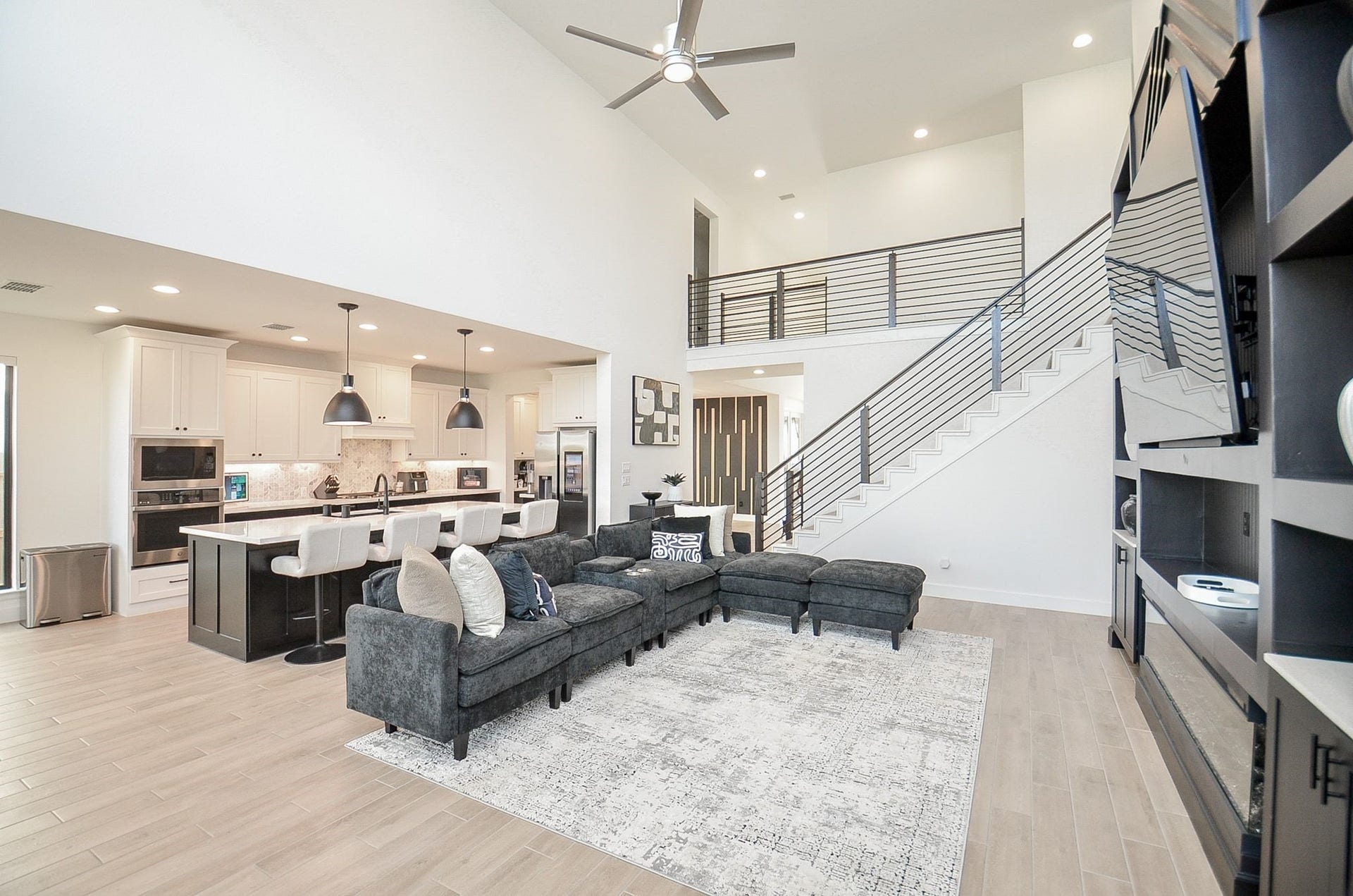 Seamless open-concept design connects the family room, kitchen, and upstairs living areas.