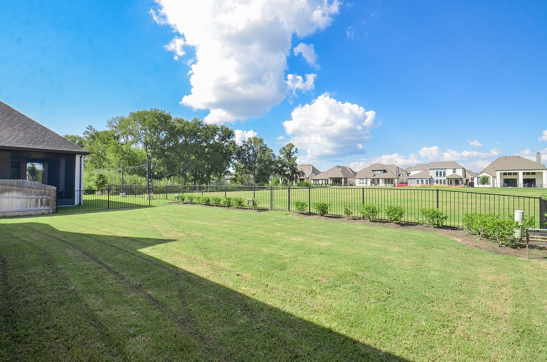 Beautifully maintained backyard overlooking expansive open green space.