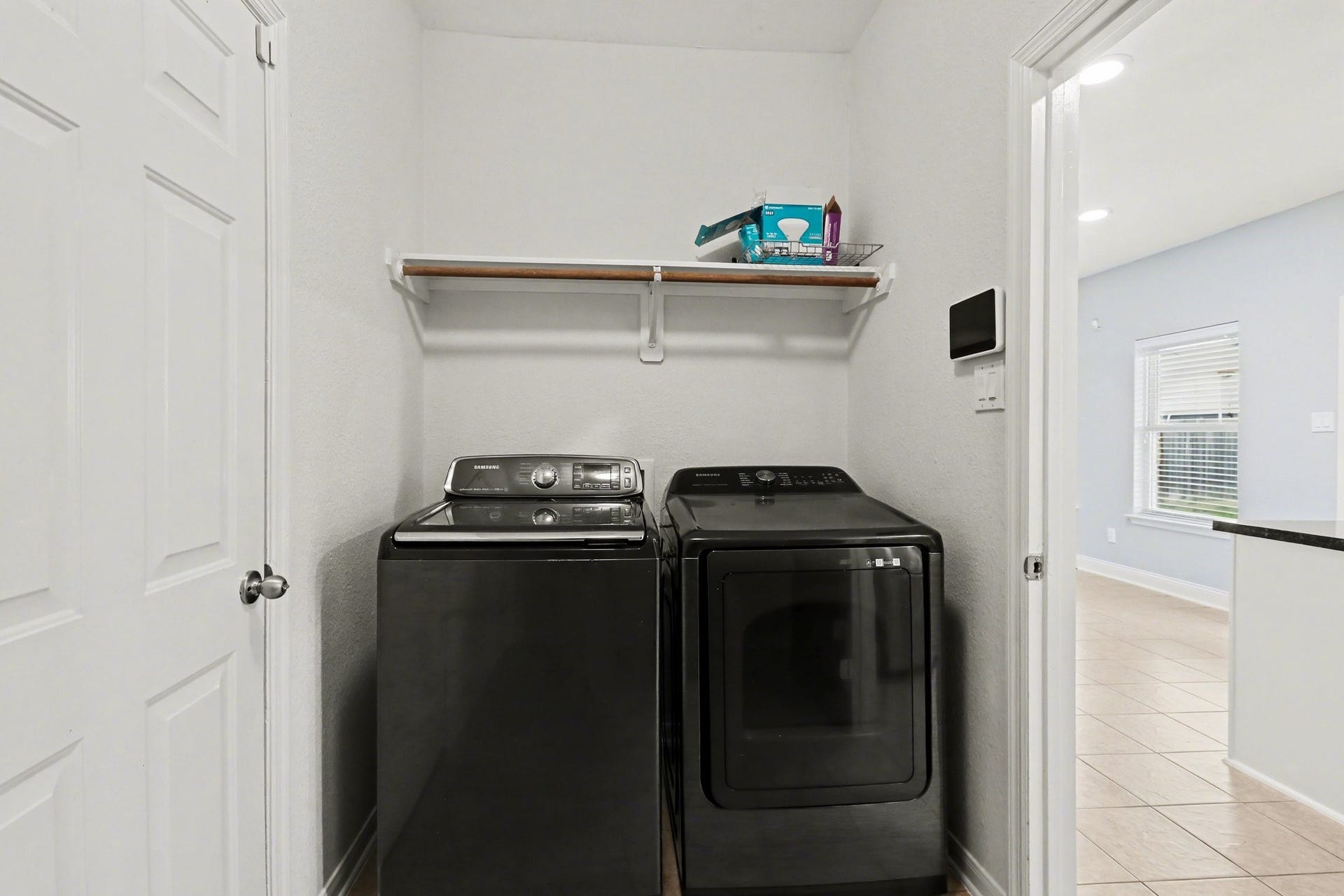2705 Golden Creek Lane, Pearland, TX 77584 The utility room is located just off the kitchen with a shelf and rod for those laundry needs!