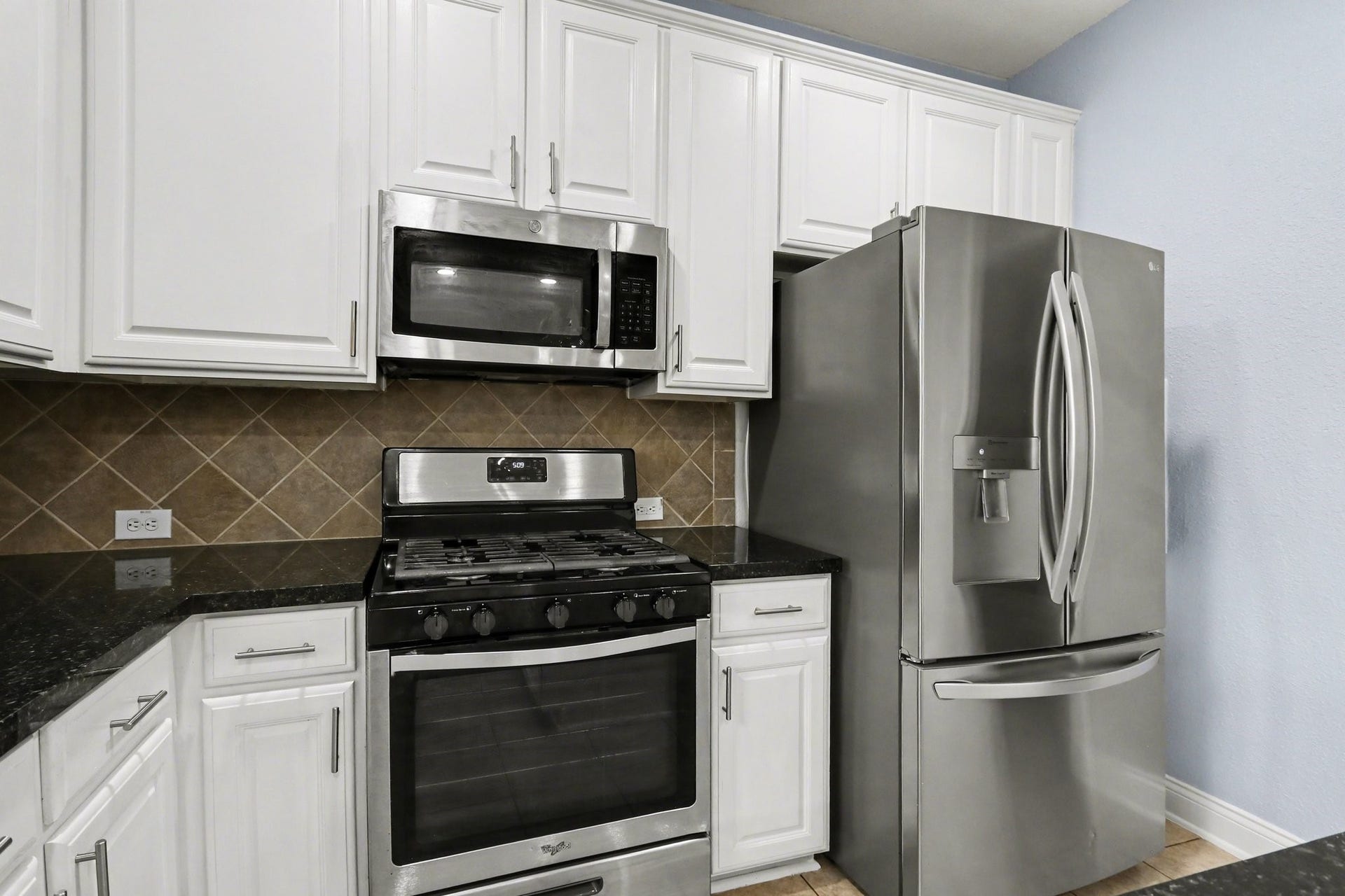 2705 Golden Creek Lane, Pearland, TX 77584 This kitchen features stainless steel appliances including a gas range, microwave and dishwasher!