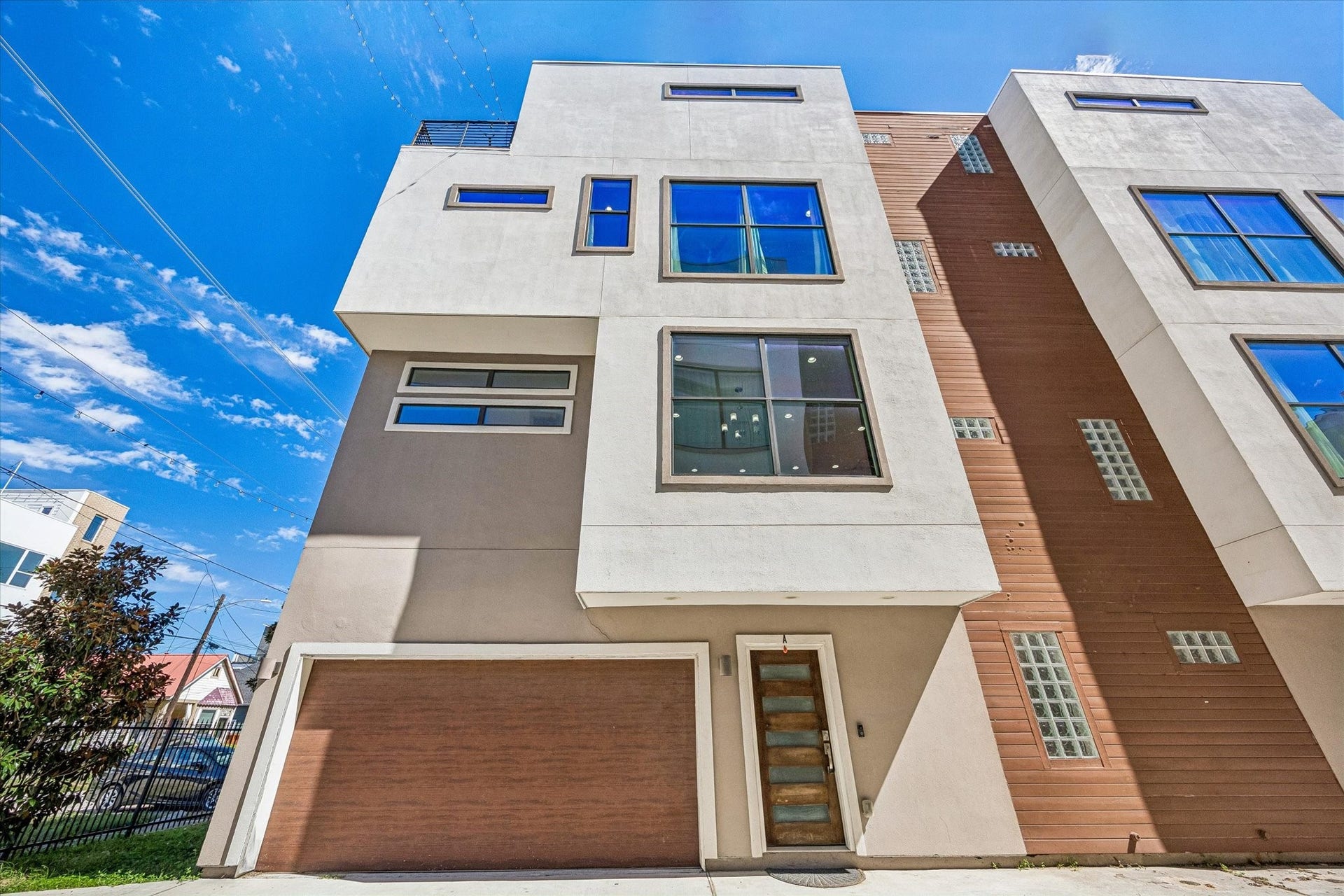 1215 Summer Street, #A, Houston, TX 77007 Contemporary exterior featuring clean architectural lines, oversized windows, an attached garage, and a glass-paneled entry door.