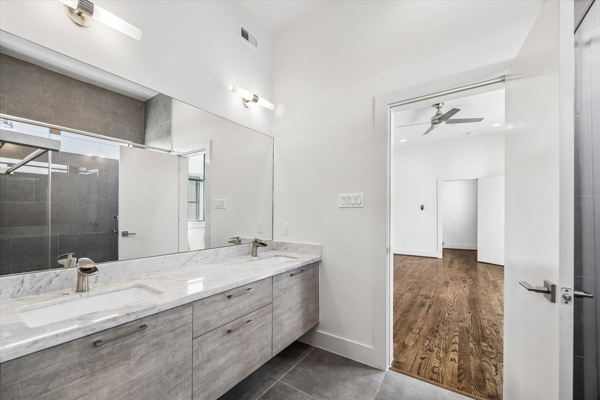 1215 Summer Street, #A, Houston, TX 77007 Extended double-sink vanity offers generous counter space and cabinet storage. The bathroom connects directly to the primary bedroom.