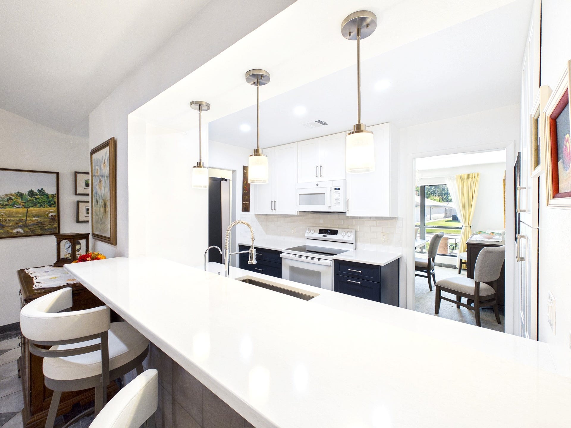 Sleek and inviting, the kitchen boasts a stylish breakfast bar perfect for casual dining and morning coffee moments.