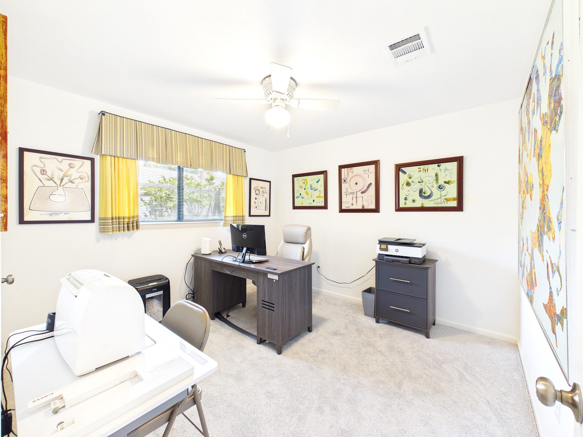 Discover the versatility of this spacious room, perfect as a productive home office or a welcoming third guest room, with ample natural light and stylish decor.