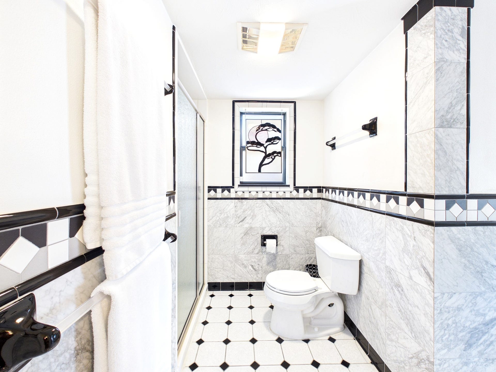 Experience elegance in this bathroom, showcasing exquisite custom tile work that adds a touch of luxury and sophistication.