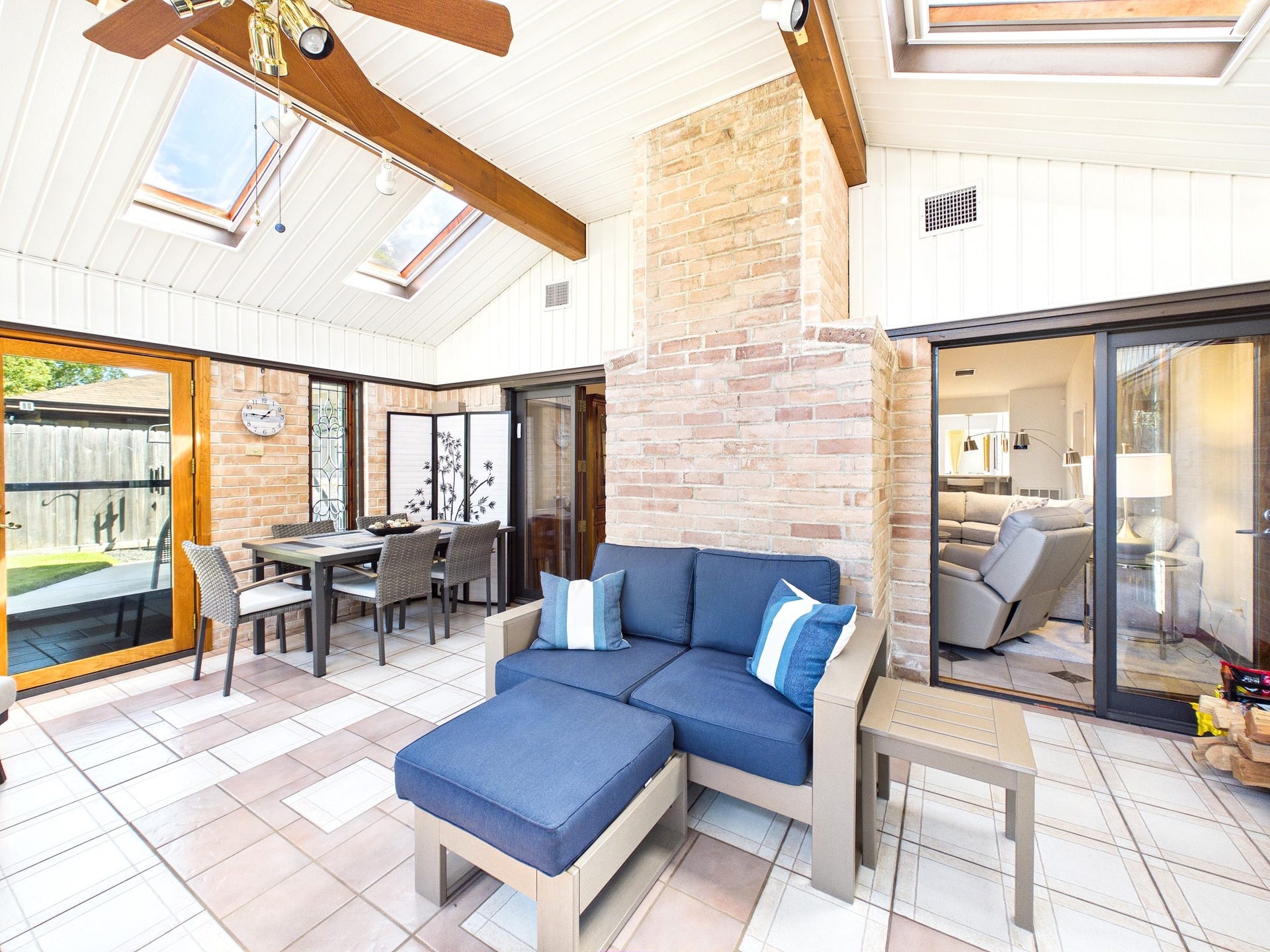 Experience the perfect blend of comfort and style in this inviting sunroom, featuring abundant natural light, cozy seating, and a charming dining area, offering great extra space for relaxation and entertaining.
