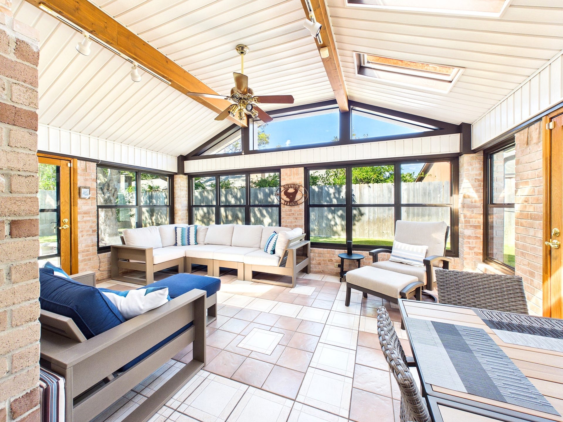 Experience year-round comfort in this spacious sunroom, featuring AC and heat, with abundant natural light and elegant finishes perfect for relaxation and entertaining.