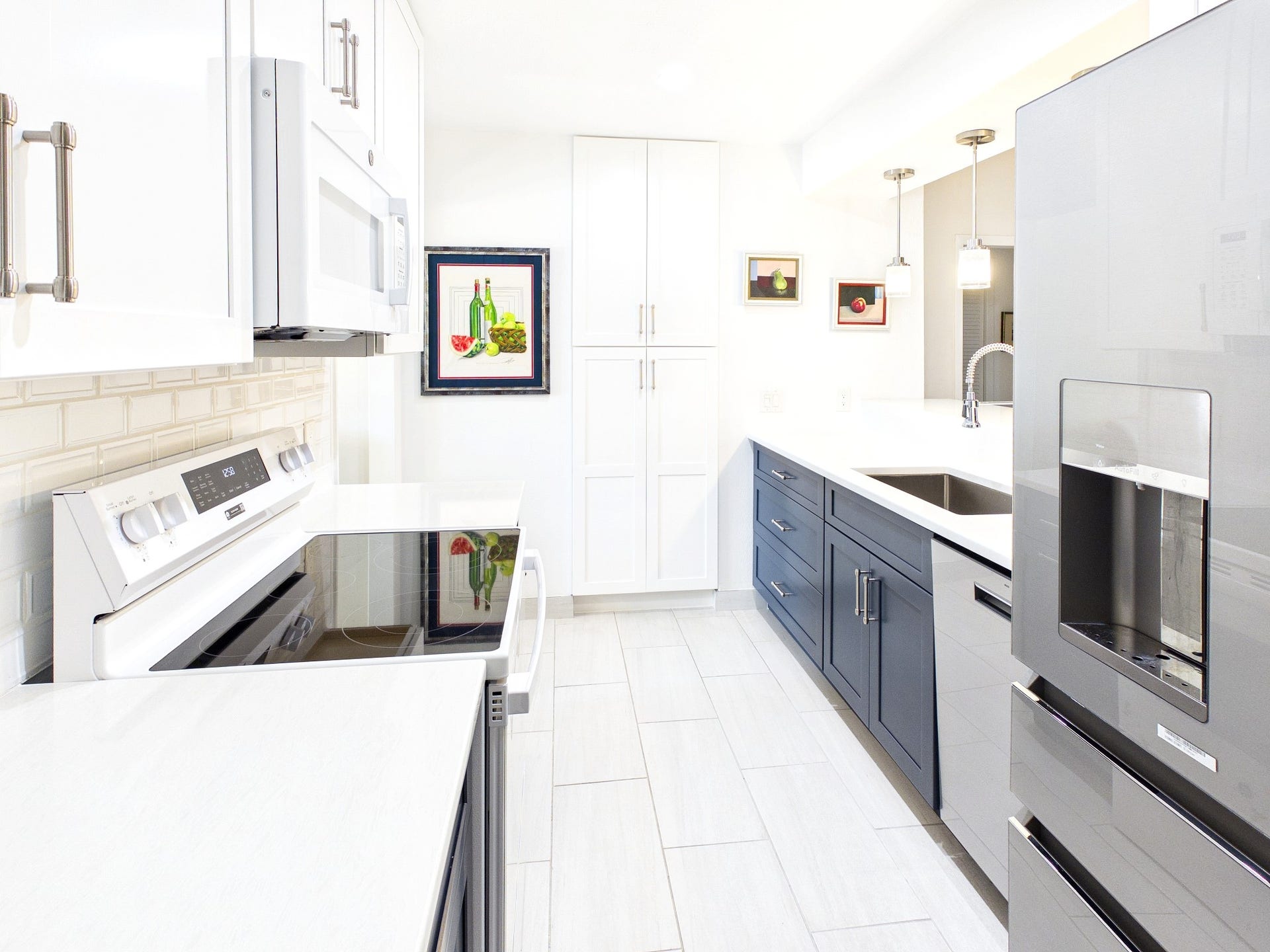 Experience modern elegance in this stunning kitchen, featuring sleek counters that perfectly complement the chic cabinetry and stainless steel appliances.