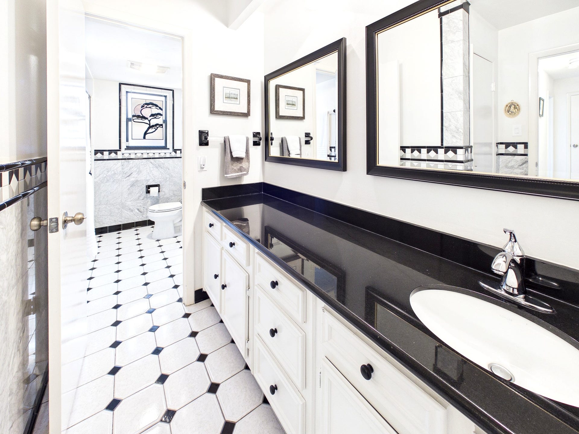 Experience the luxury of a shared bath with distinct separate rooms, combining privacy and elegance in a beautifully designed space.
