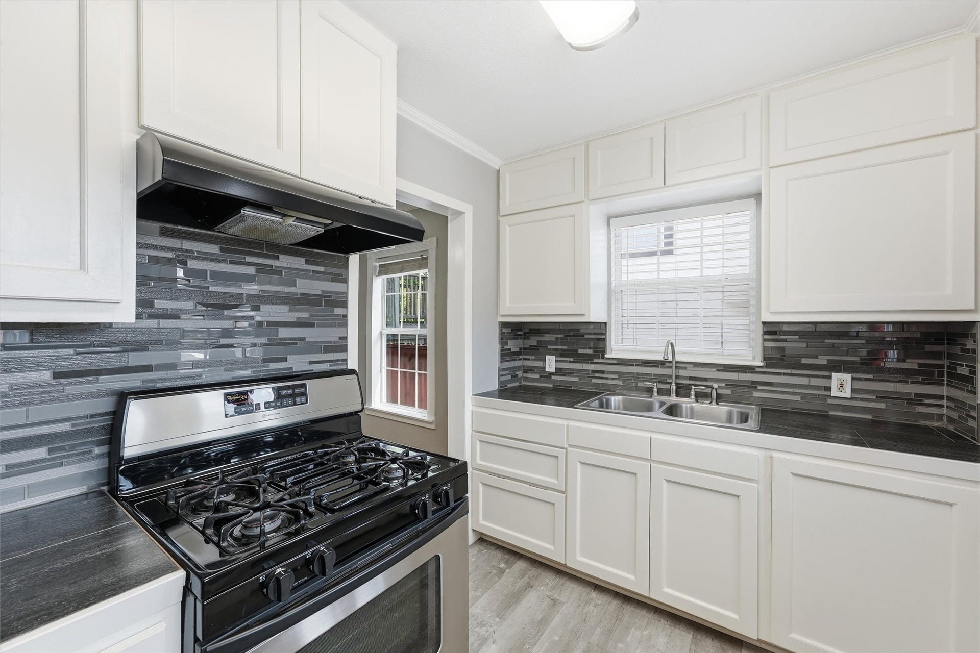 4823 Bernardo De Galvez, Galveston, TX 77551 Kitchen features glass block backsplash and tile countertops.