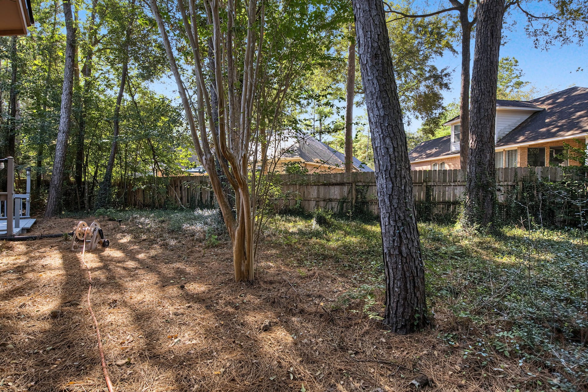 51 Pinery Ridge Place, The Woodlands, TX 77382 Mature trees and a fenced backyard provide an established outdoor setting with opportunities to create your own garden or gathering space.