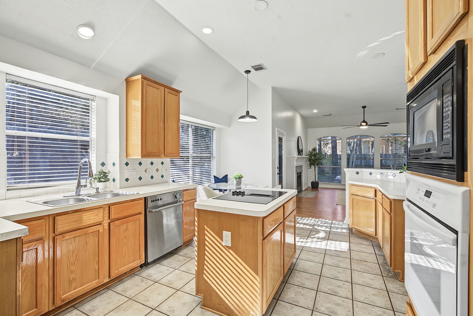 51 Pinery Ridge Place, The Woodlands, TX 77382 The island kitchen offers generous cabinetry, extensive counter space, and a connection to the breakfast area and living room.