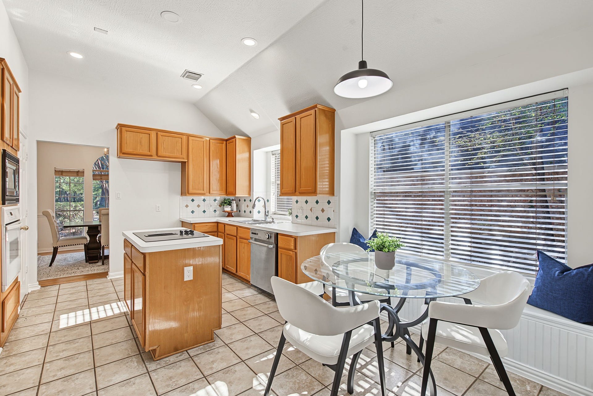 51 Pinery Ridge Place, The Woodlands, TX 77382 A center island, breakfast nook, and updated lighting provide a starting point for a kitchen you can personalize to your taste.