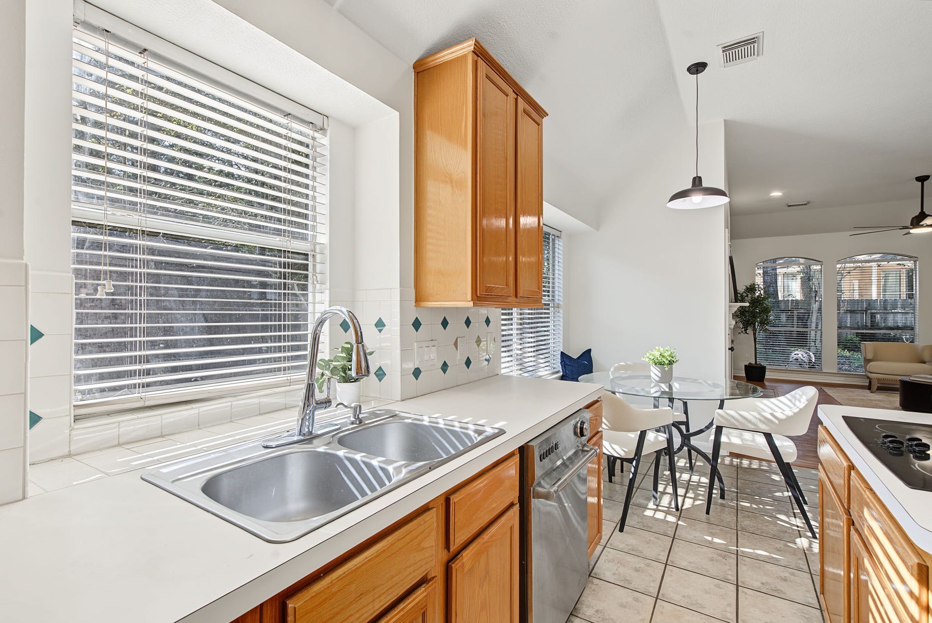 51 Pinery Ridge Place, The Woodlands, TX 77382 A window above the double-basin sink brings natural light to the workspace, with nearby cabinetry keeping everyday essentials within reach.