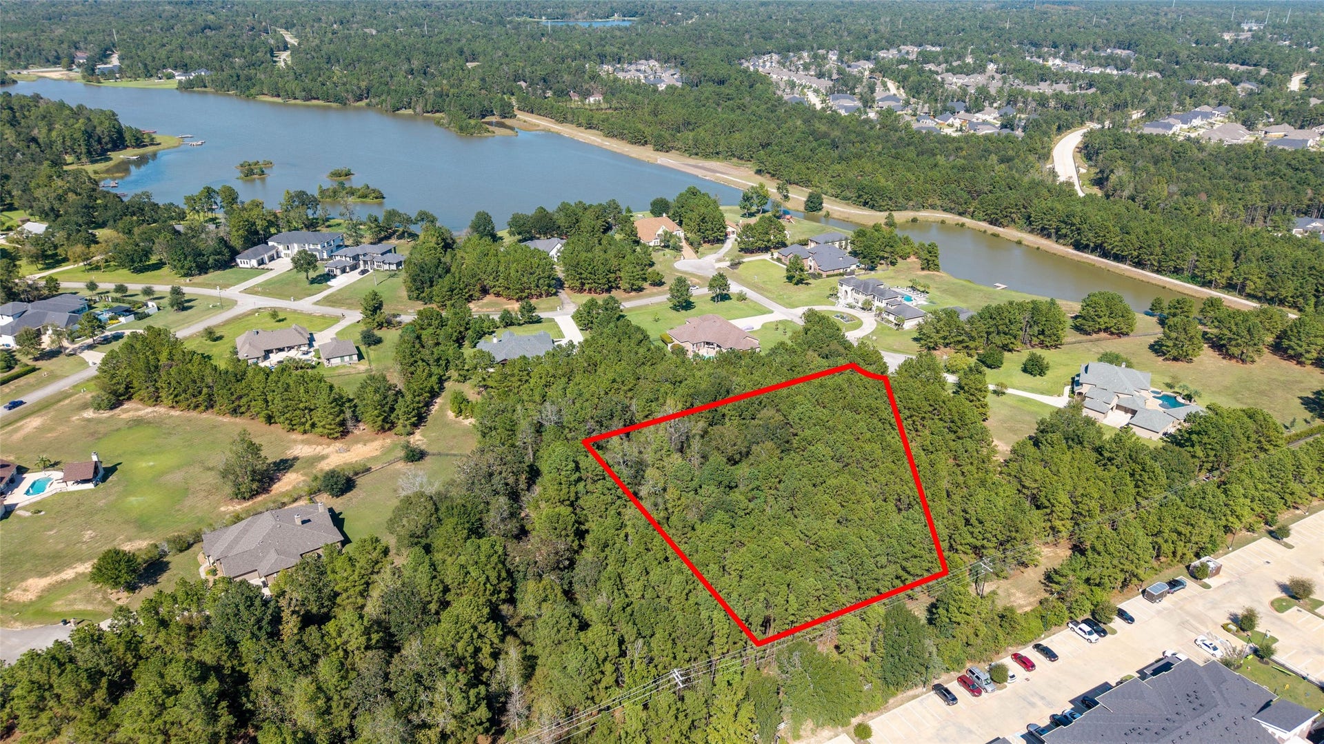 0 Ridgelake Court, Montgomery, TX 77316 Expansive wooded lot outlined in red, nestled in a serene neighborhood with nearby water views, offering a perfect setting for building your dream home.