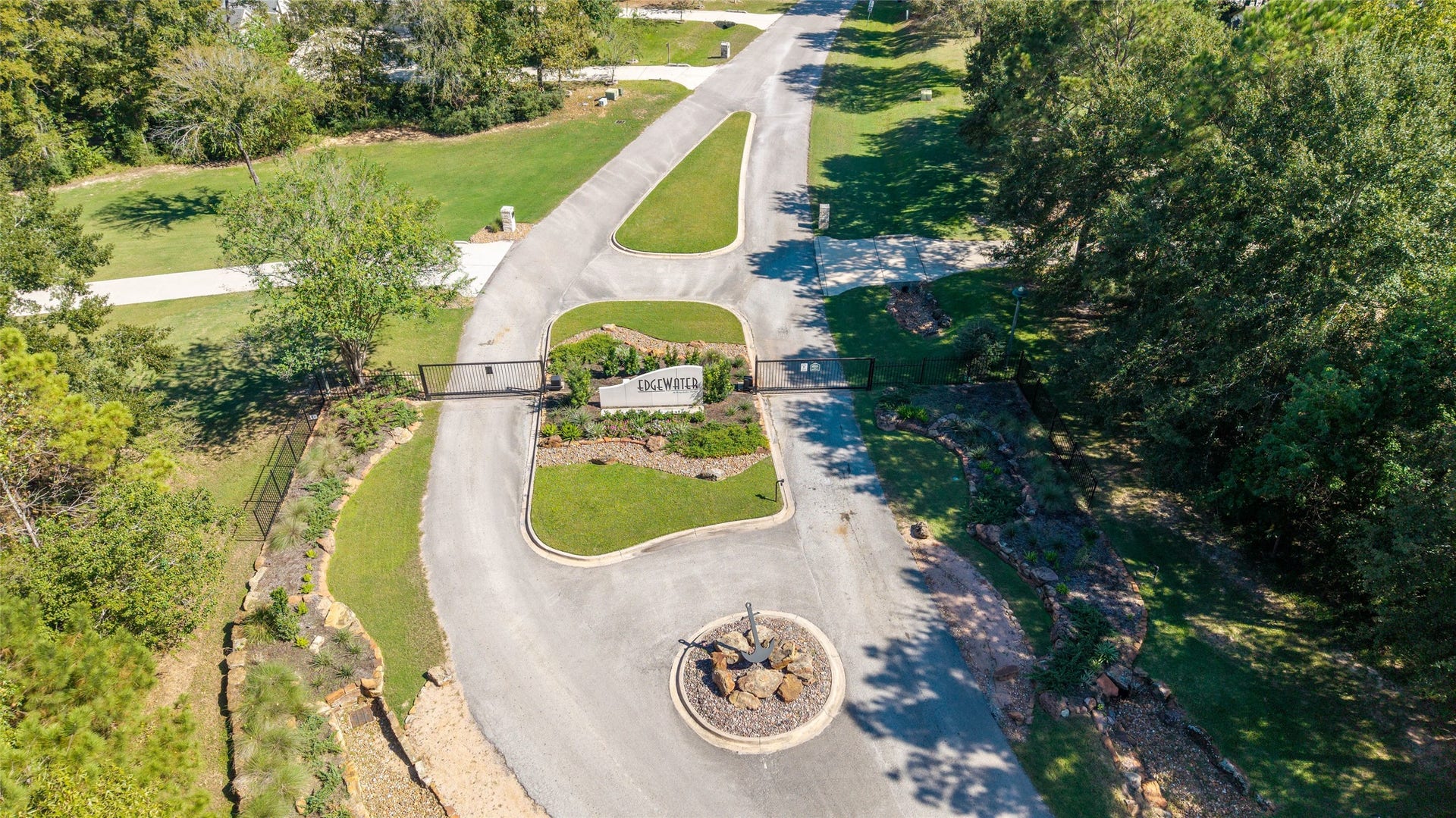 0 Ridgelake Court, Montgomery, TX 77316 Gated entrance to a serene community, surrounded by lush greenery and well-maintained landscaping, offering privacy and exclusivity.