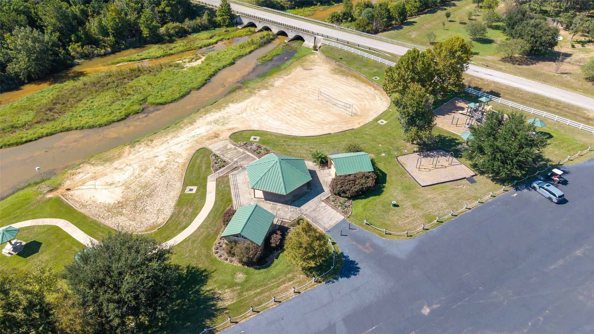 0 Ridgelake Court, Montgomery, TX 77316 Enjoy outdoor living with this spacious recreational area featuring a sand volleyball court, basketball court, playground, and scenic walking paths next to a tranquil creek.