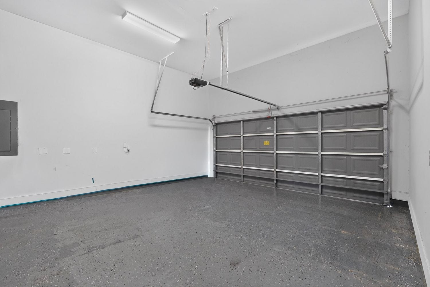 9820 Mocking Bird Hill Lane, Houston, TX 77080 Spacious garage with a sleek, durable epoxy floor and ample overhead lighting, perfect for storage or projects.