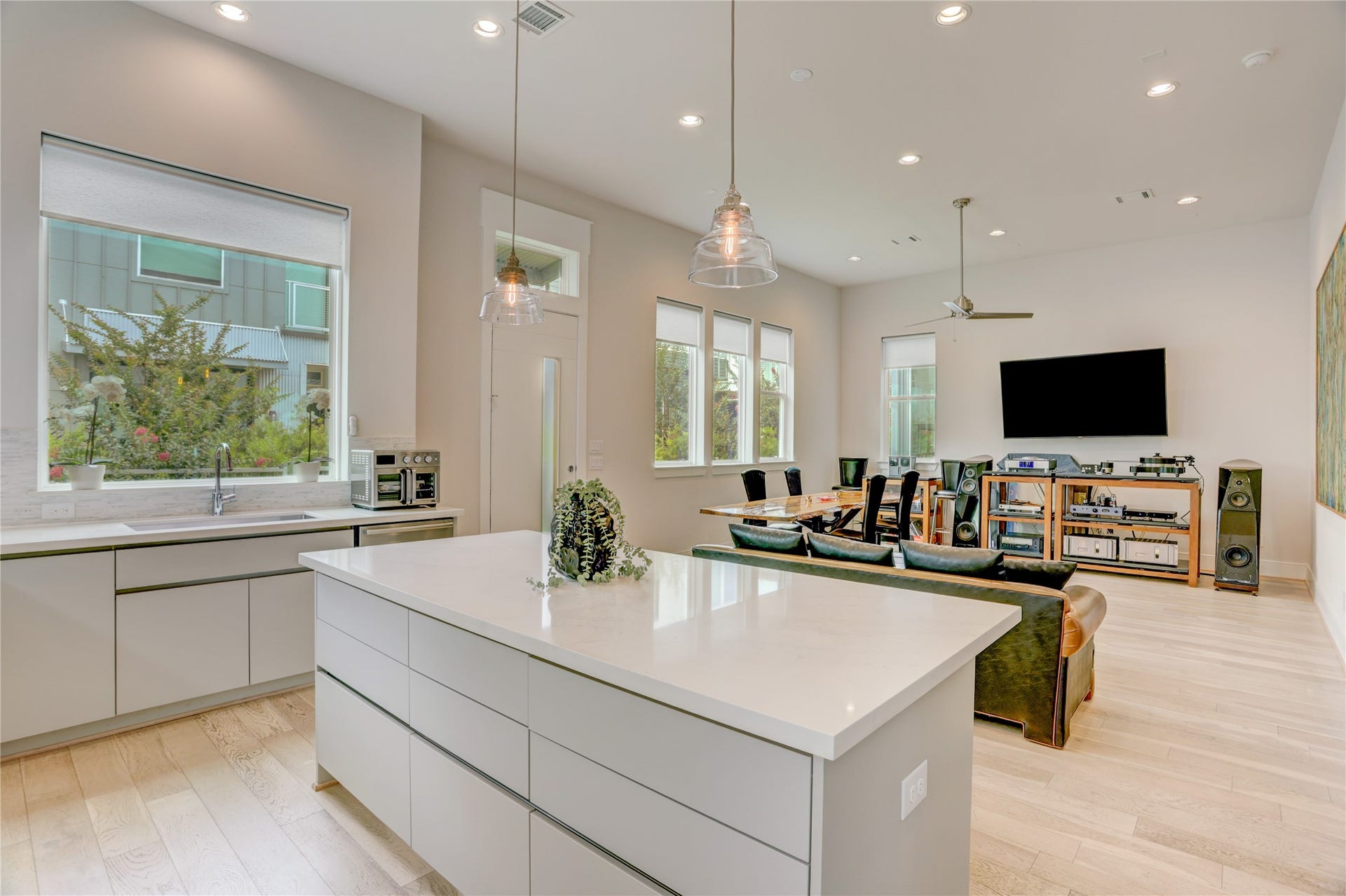 9820 Mocking Bird Hill Lane, Houston, TX 77080 Spacious open-concept living area with modern kitchen, large island, and abundant natural light, perfect for entertaining.