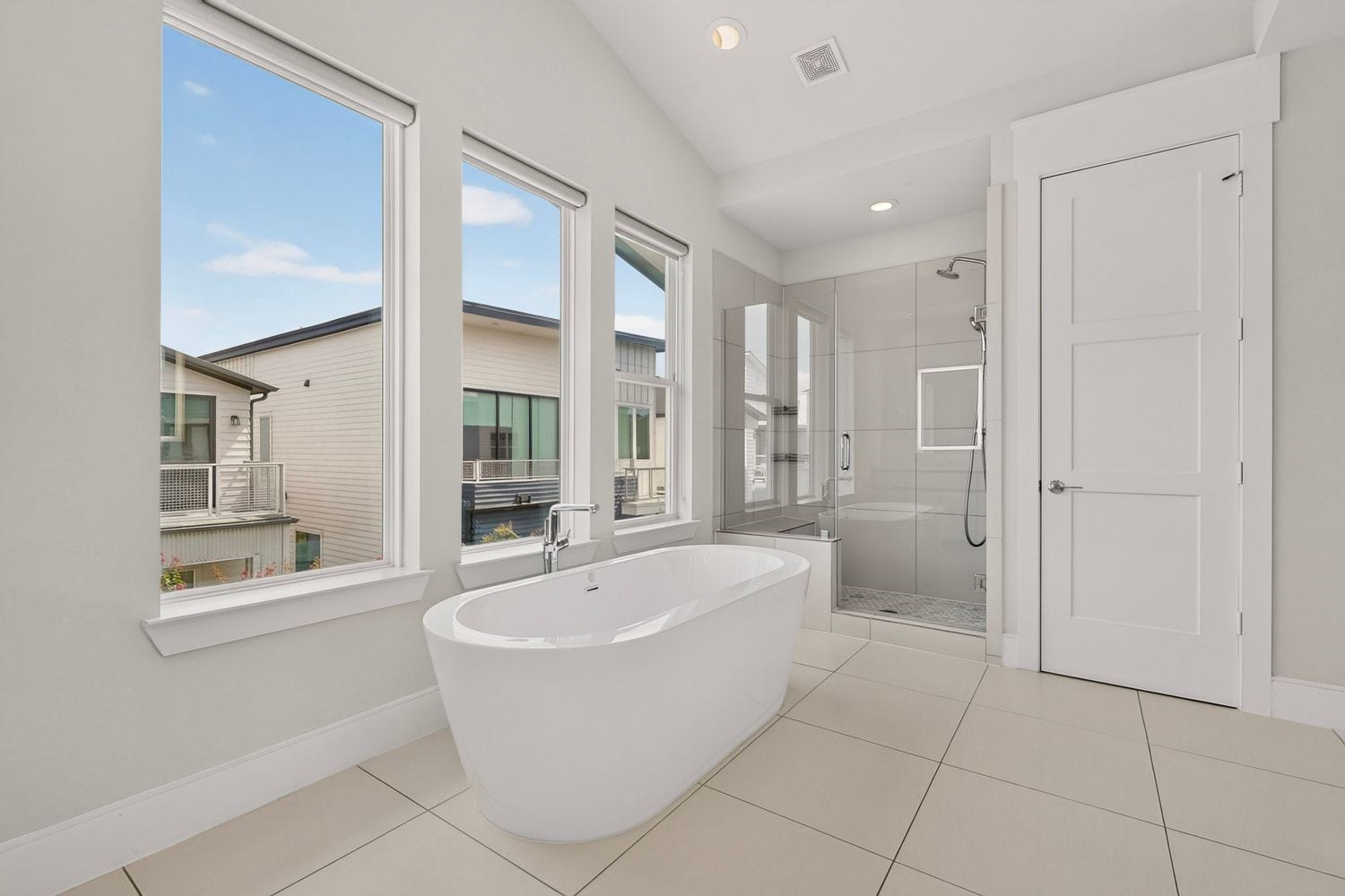 9820 Mocking Bird Hill Lane, Houston, TX 77080 Luxurious bathroom featuring a freestanding soaking tub, large walk-in shower, and abundant natural light from multiple windows.