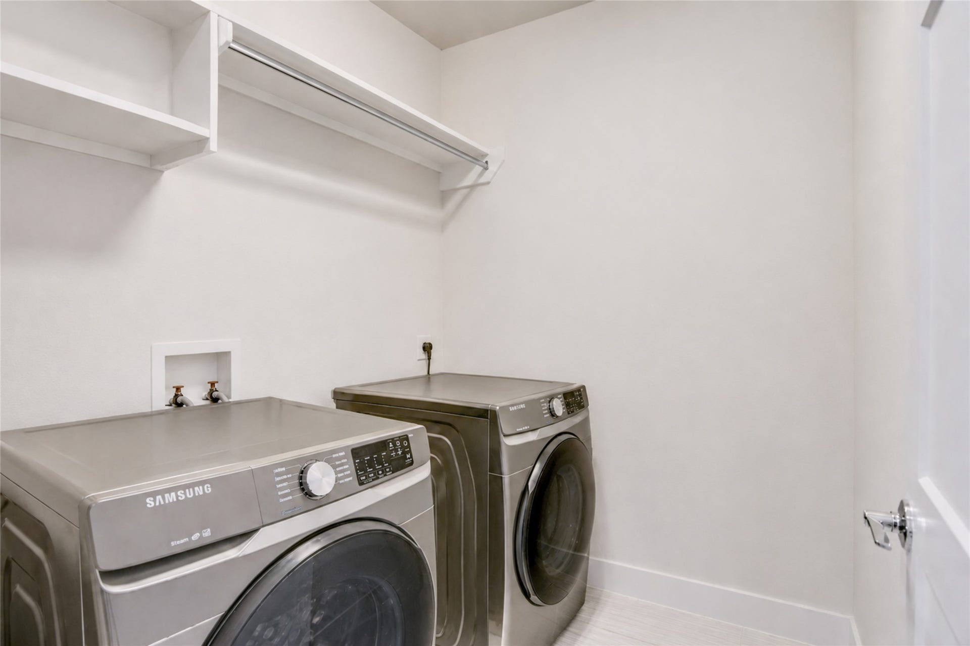 9820 Mocking Bird Hill Lane, Houston, TX 77080 Spacious laundry room featuring modern appliances, ample shelving, and a sleek, clean design.