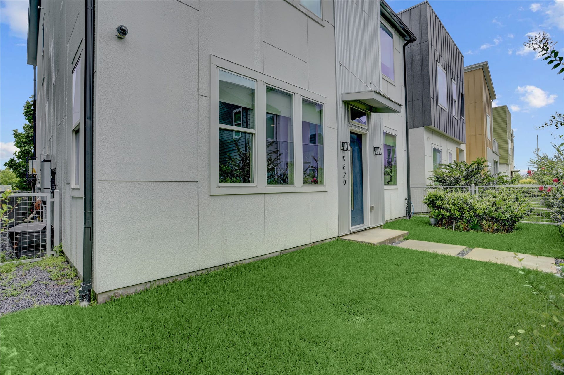 9820 Mocking Bird Hill Lane, Houston, TX 77080 Standing in your yard, you see your modern sleek exterior with large windows and a well-maintained front lawn, offering contemporary style and curb appeal.