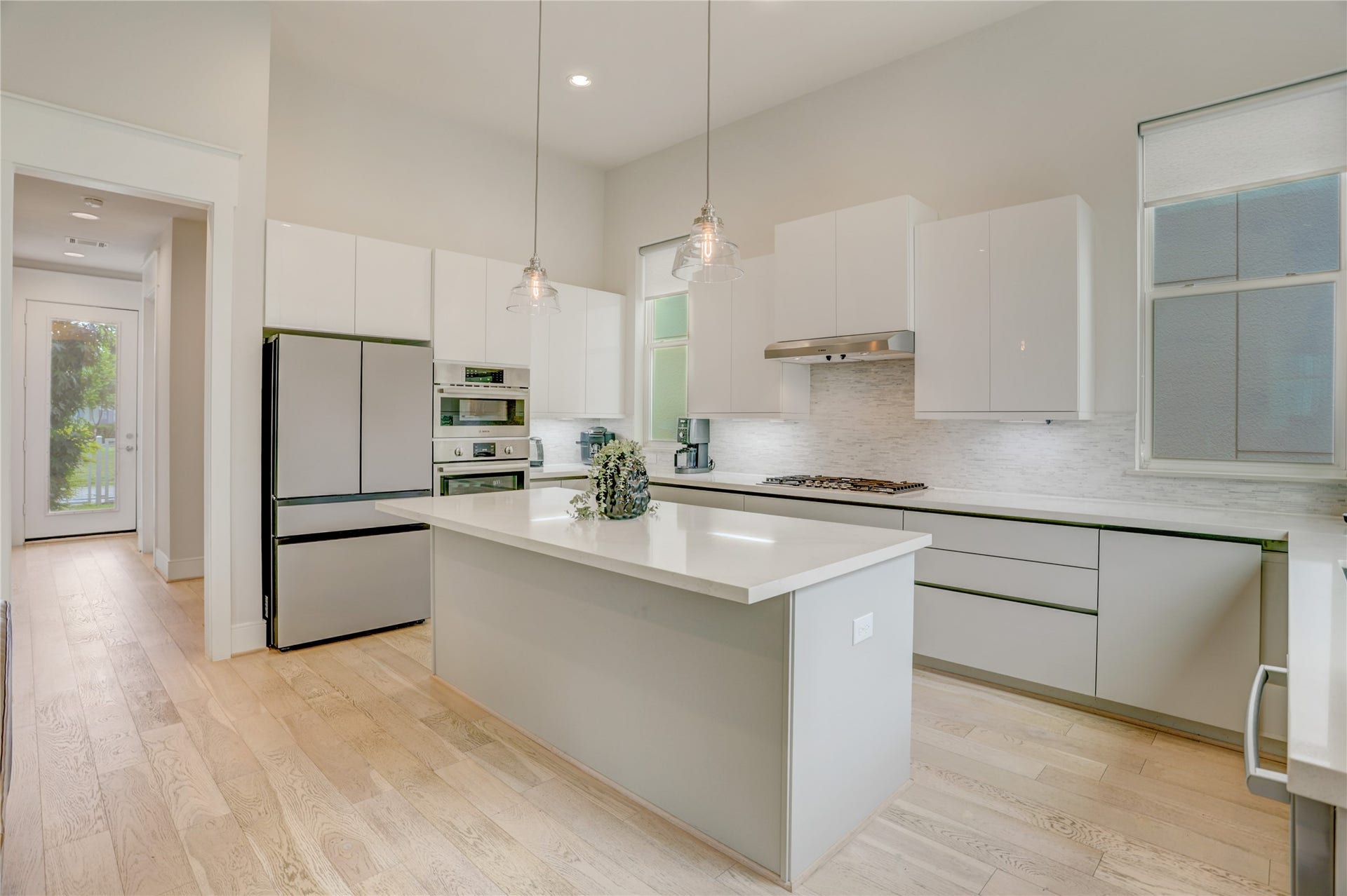 9820 Mocking Bird Hill Lane, Houston, TX 77080 Bright and modern kitchen featuring sleek cabinetry, stainless steel appliances, and a spacious island with pendant lighting.