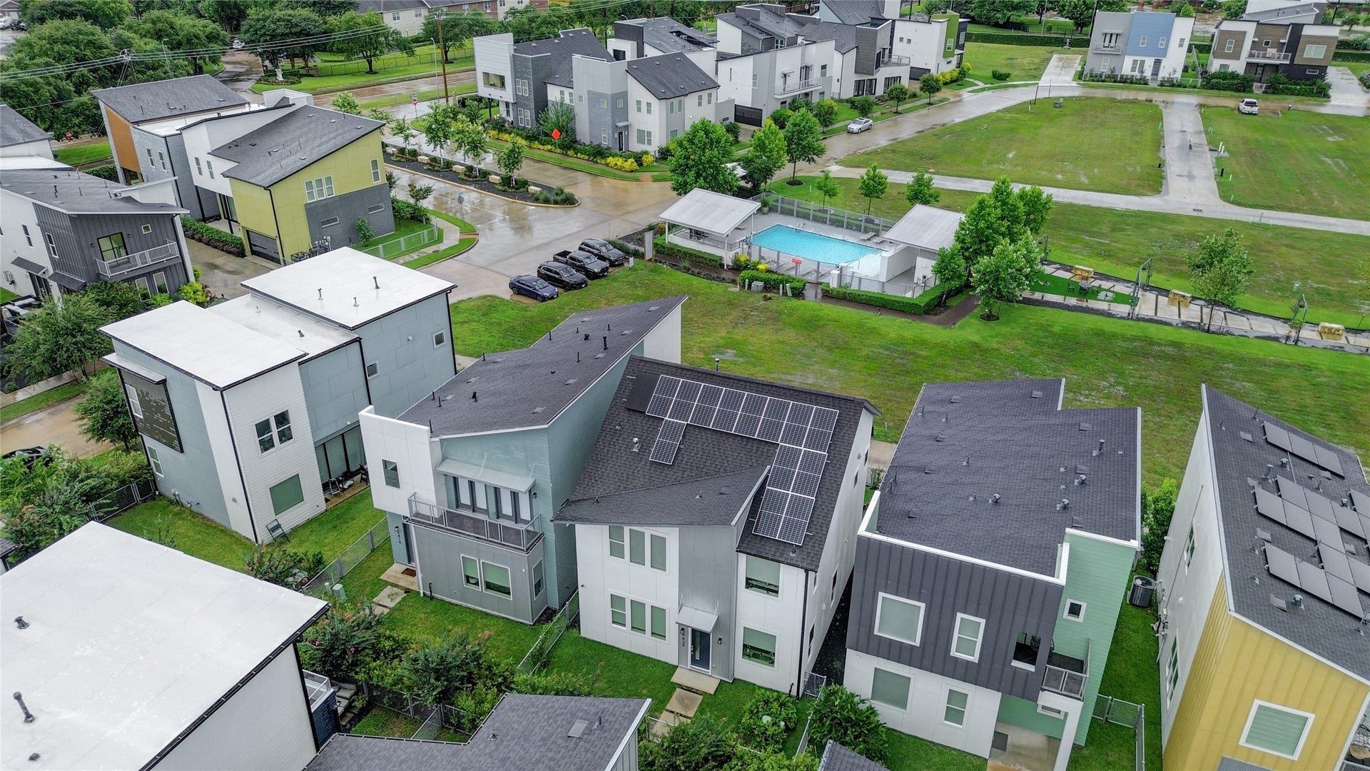 9820 Mocking Bird Hill Lane, Houston, TX 77080 Modern, eco-friendly homes with sleek designs and solar panels, set in a community featuring a private pool and lush green spaces.