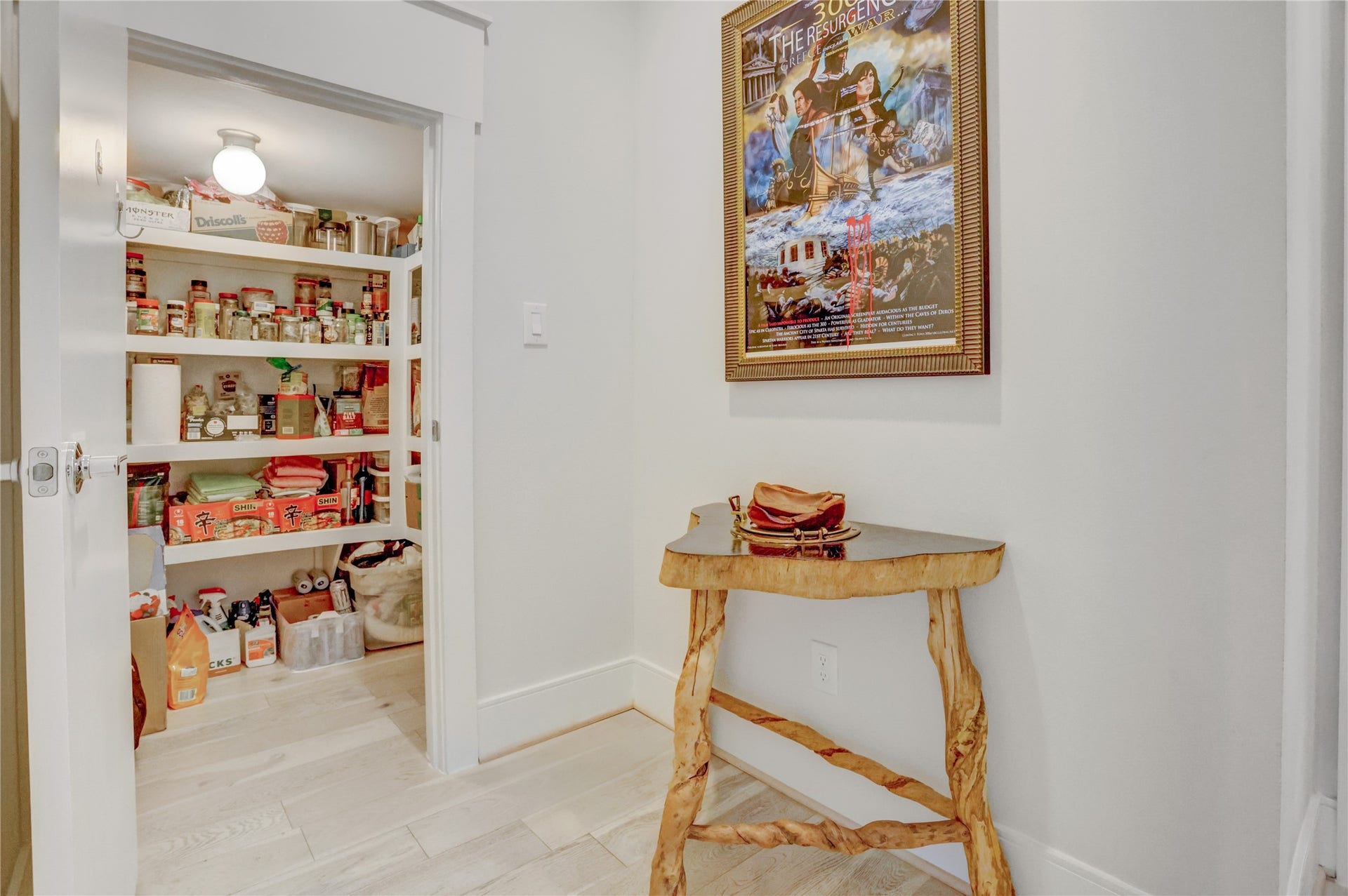 9820 Mocking Bird Hill Lane, Houston, TX 77080 A neatly organized pantry with ample shelving provides convenient storage, while the adjacent hallway adding charm to the space.