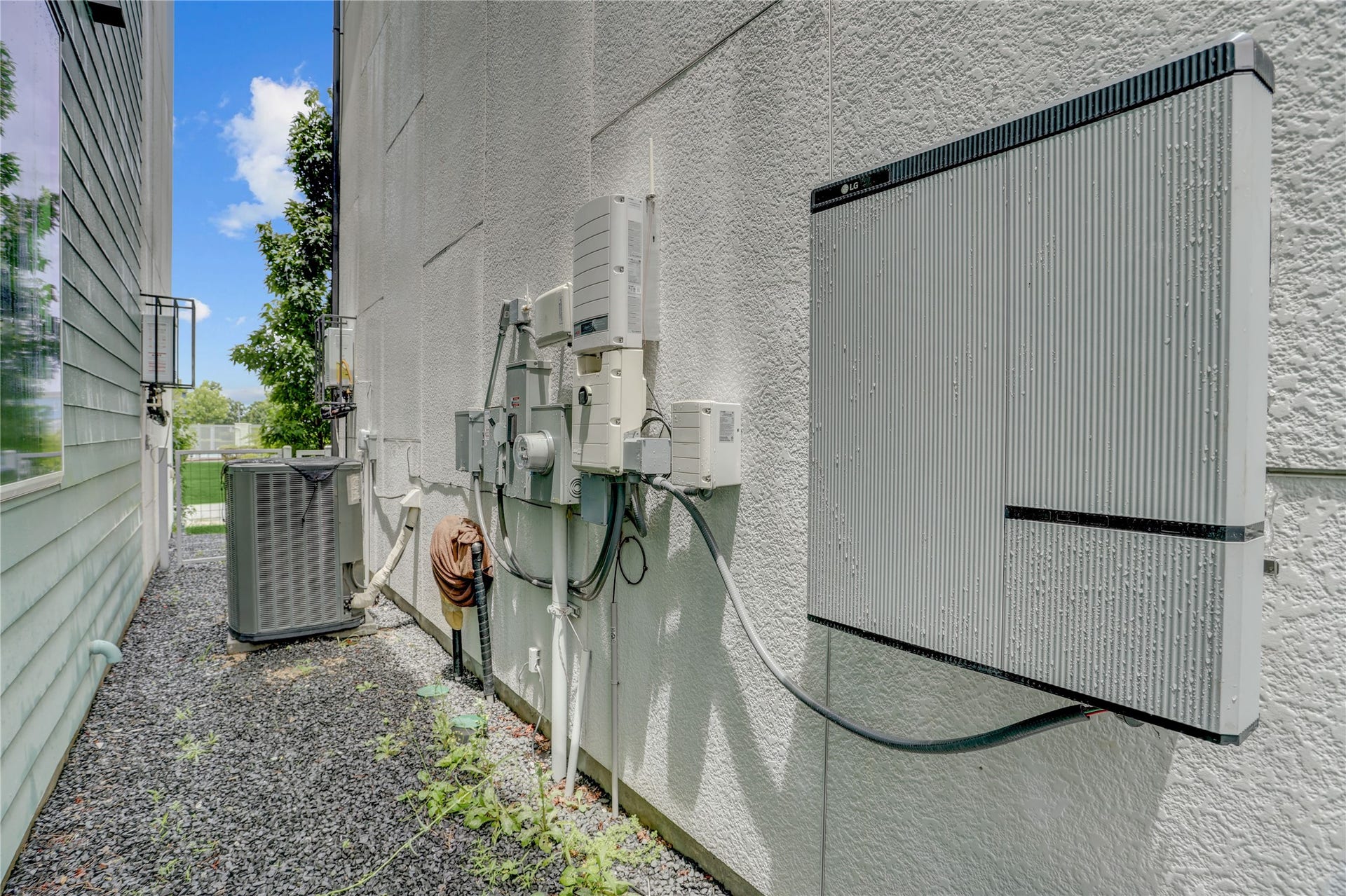 9820 Mocking Bird Hill Lane, Houston, TX 77080 The battery backup system is shown along with the Neatly organized utilities and an efficient air conditioning unit enhance this home's exterior functionality.