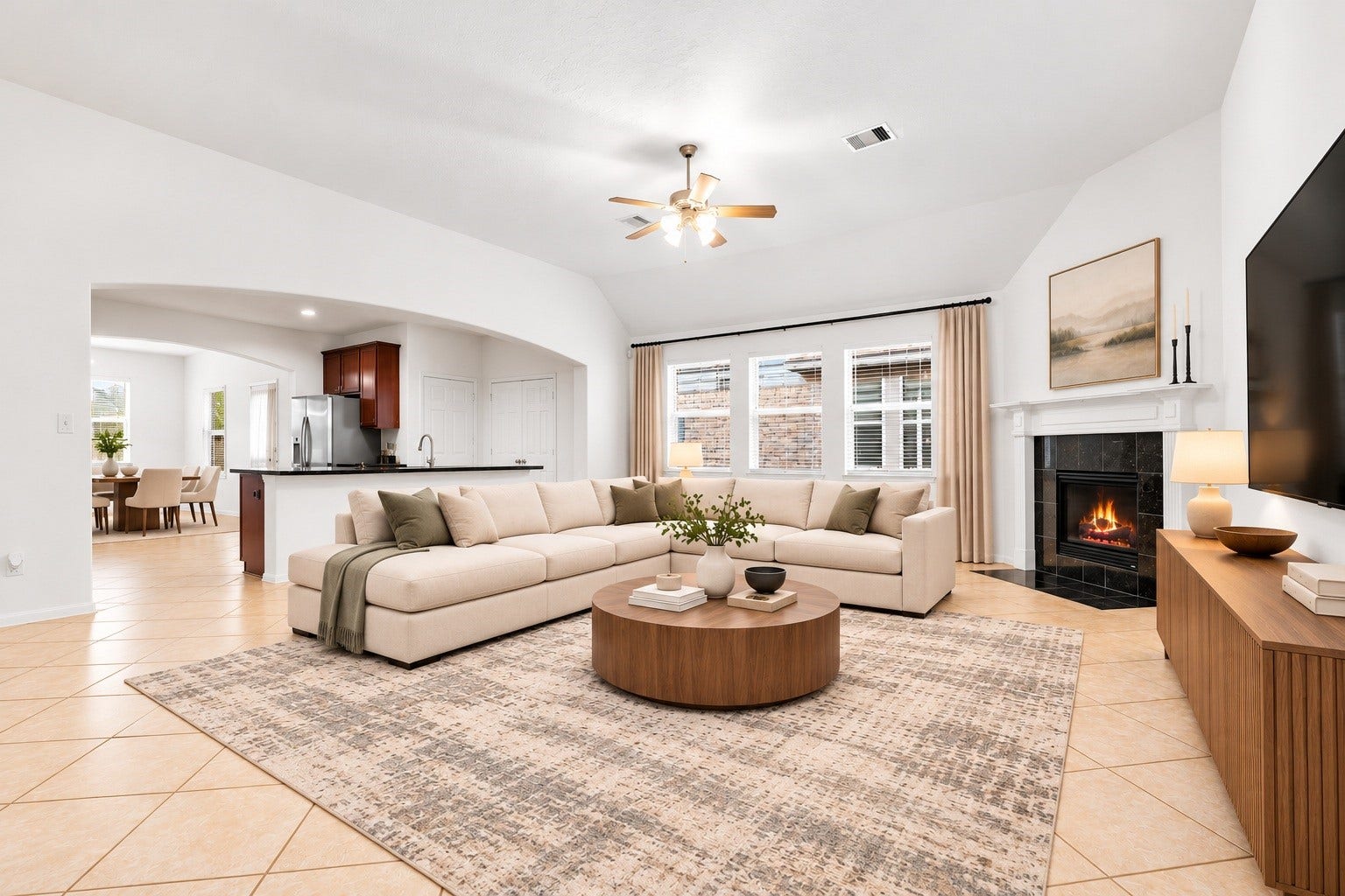 26311 Smokey Valley Lane, Katy, TX 77494 Natural light pours through three windows dressed in new blinds, while a wide arched opening links the family room to the kitchen for a cozy, connected floor plan. Virtually staged.