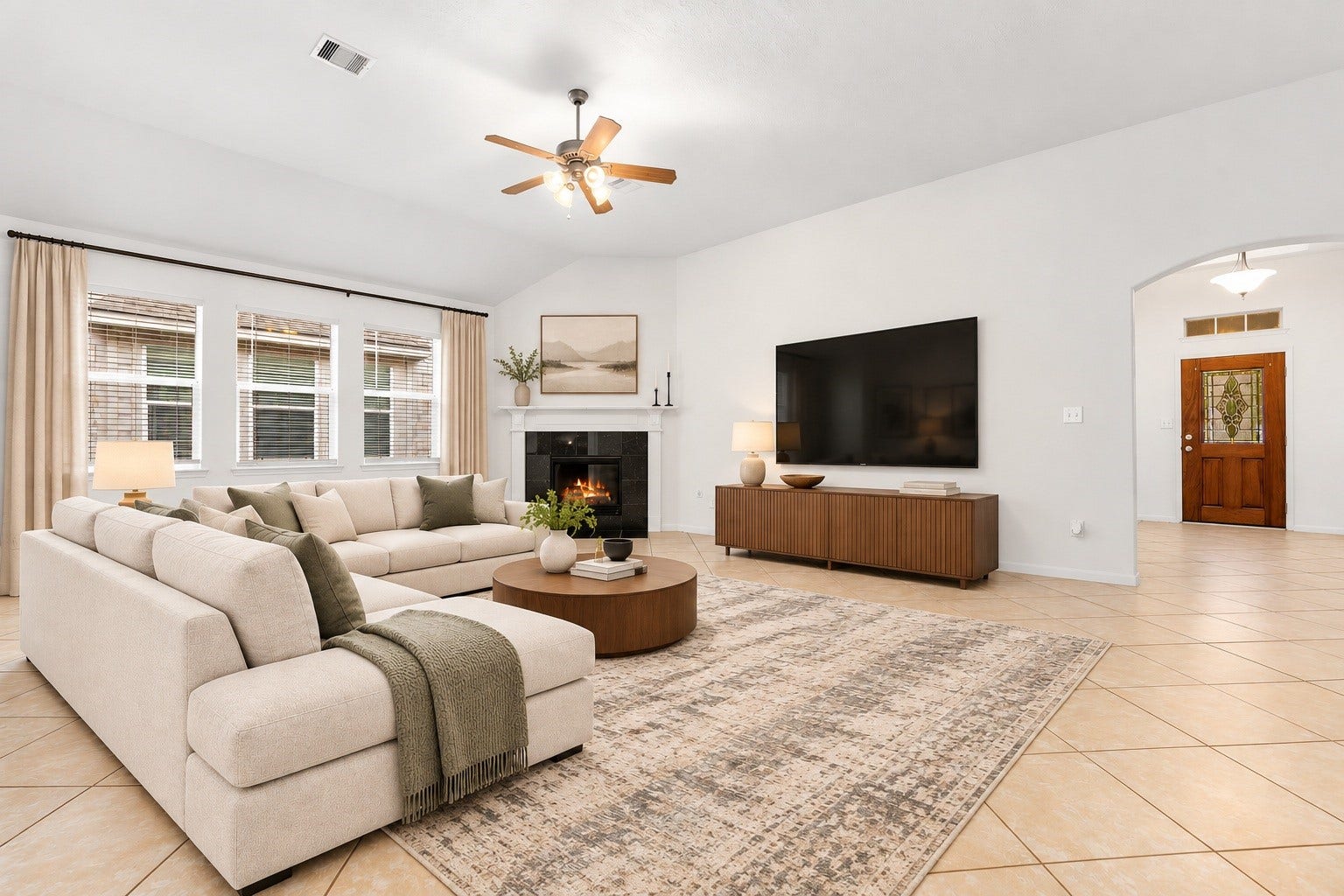 26311 Smokey Valley Lane, Katy, TX 77494 Gather around the refurbished gas log fireplace, the heart of the family room. A crisp white mantel and dark tile surround sit beneath a soaring vaulted ceiling with a ceiling fan. Virtually staged.