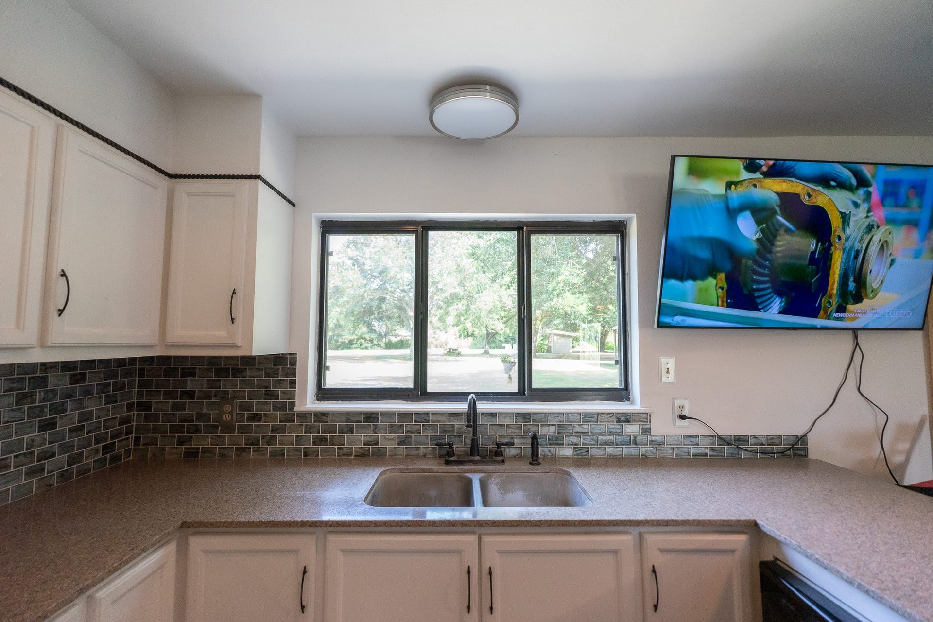3015 Indian Acres Street, Alvin, TX 77511 A sink with a view into the backyard.