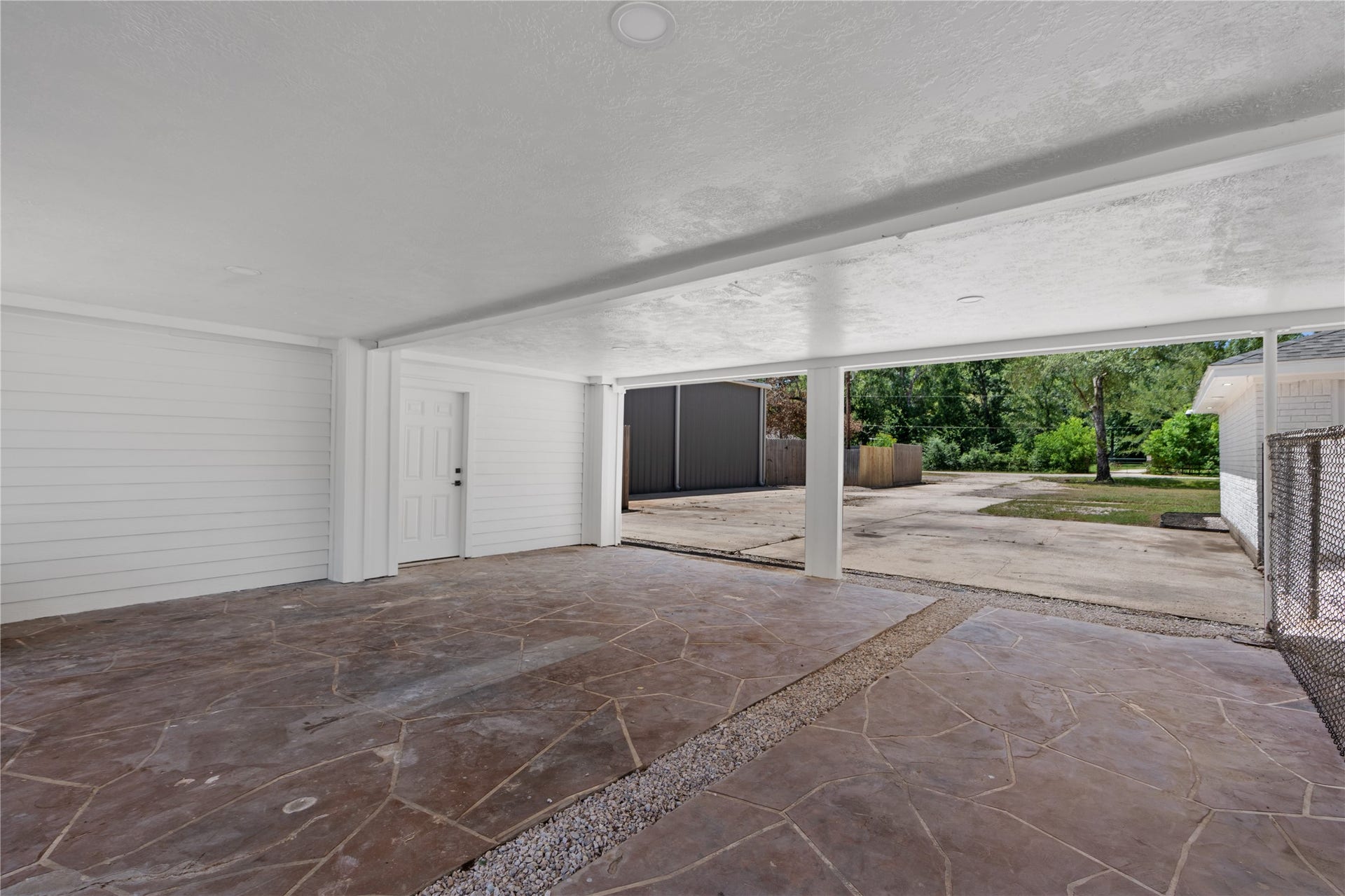 12019 Beth Lane, Magnolia, TX 77354 Lots of Parking Options- Including this Covered carport with Led lighting, Stamped Concrete, and even a 250 SF storage area with 1/2 Bath for quick outside access of make it the workshop bath! Plumbed for shower install.