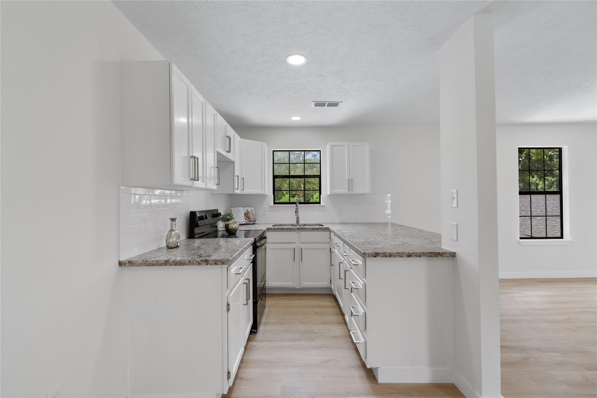 12019 Beth Lane, Magnolia, TX 77354 Modern Details in the Apartment Kitchen, New Sink, Hardware, Garbage Disposal, Granite Countertops, Subway tiled backsplash. New Stove and oven, lots of storage space.