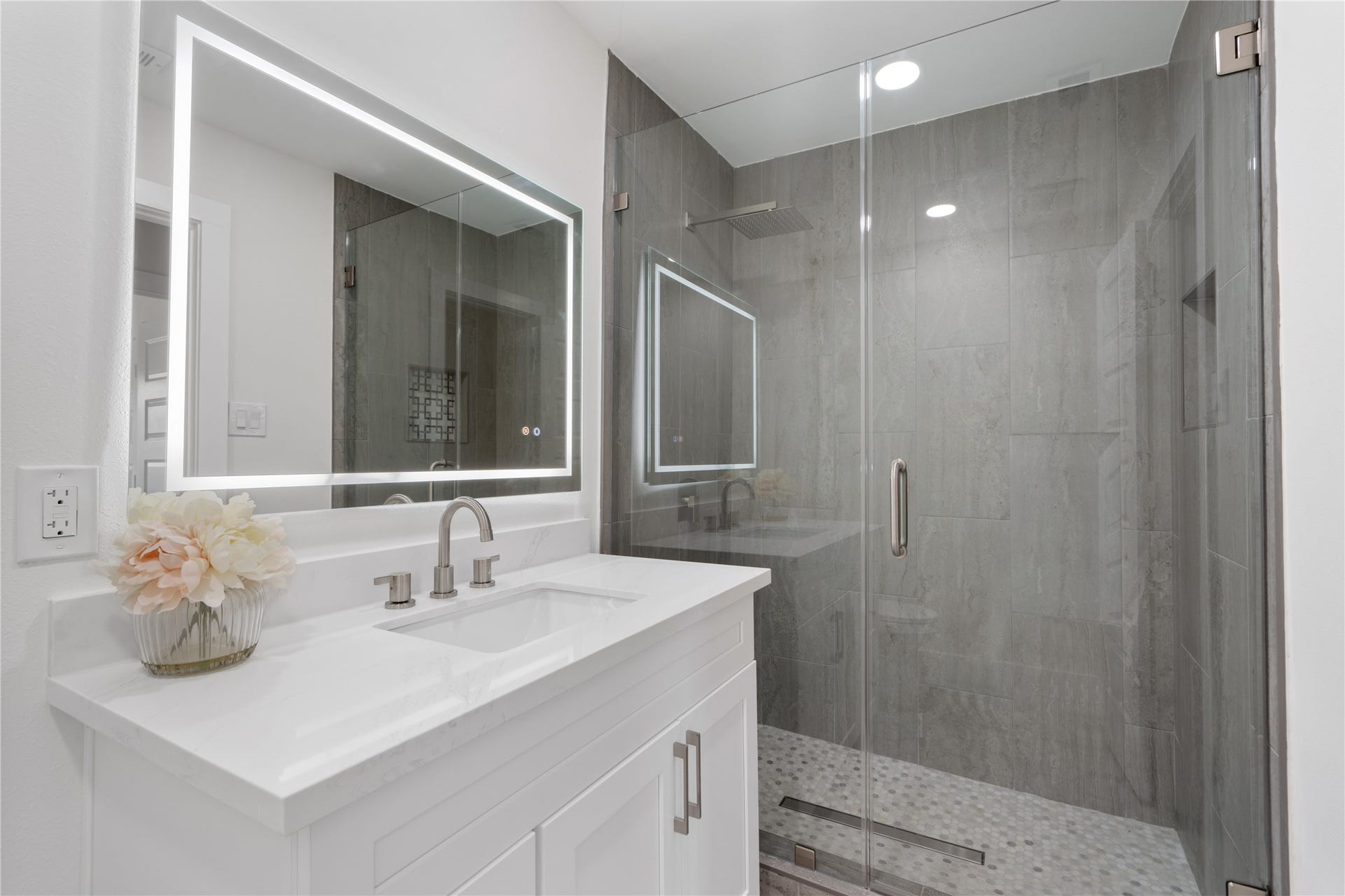 12019 Beth Lane, Magnolia, TX 77354 Another stunning full bath with tile detail, quartz countertops, led mirror with fog proof and multiple lighting settings, custom shower glass door.