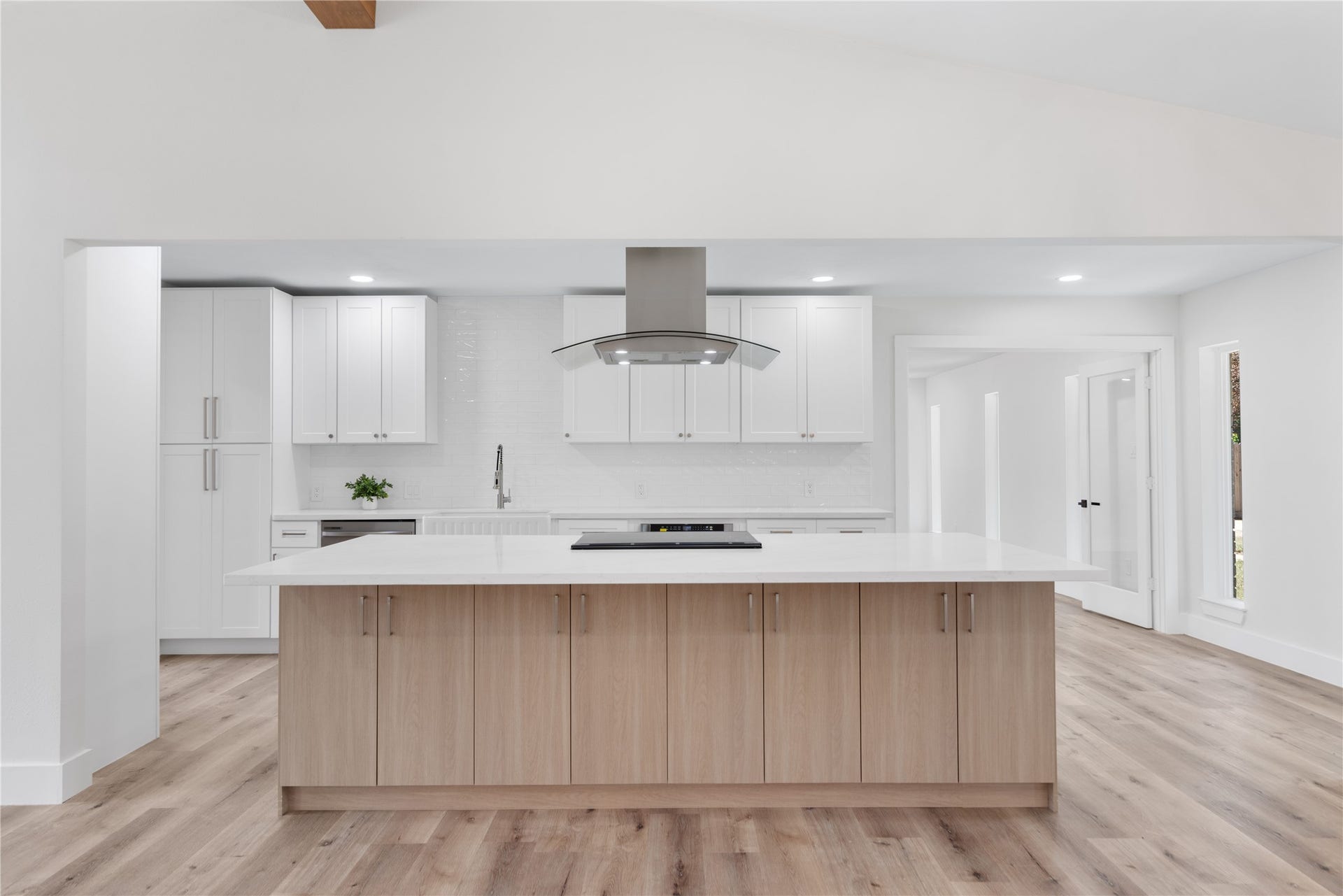 12019 Beth Lane, Magnolia, TX 77354 Wow this Gourmet kitchen is fully equipped with an oversized Island kitchen that makes a statement- loaded with storage, quartz countertops, 36" cooktop, glass vent hood, modern hardware, under counter drawer microwave, porcelain farmhouse sink.