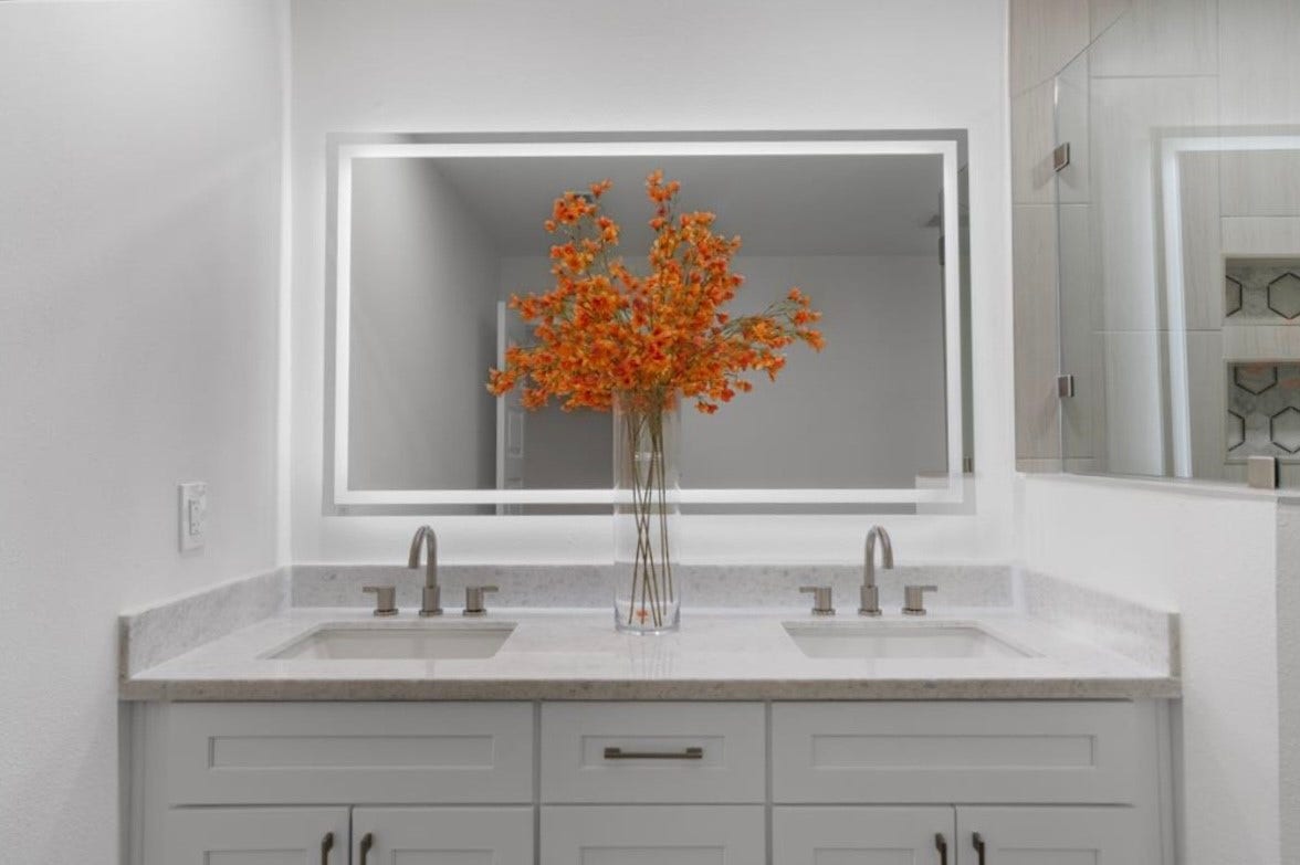 12019 Beth Lane, Magnolia, TX 77354 Primary Bath adorned with his and her sink, soft close drawers and cabinets for storage, quartz countertops, modern hardware, and a oversized led front and backlit mirror with steam proof feature and multiple lighting settings.