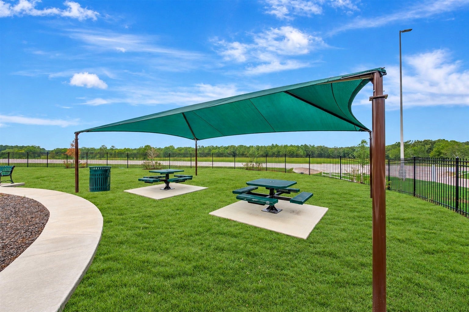 313 Brocks Court, Montgomery, TX 77356 Charming community picnic tables, ideal for gatherings and relaxation.