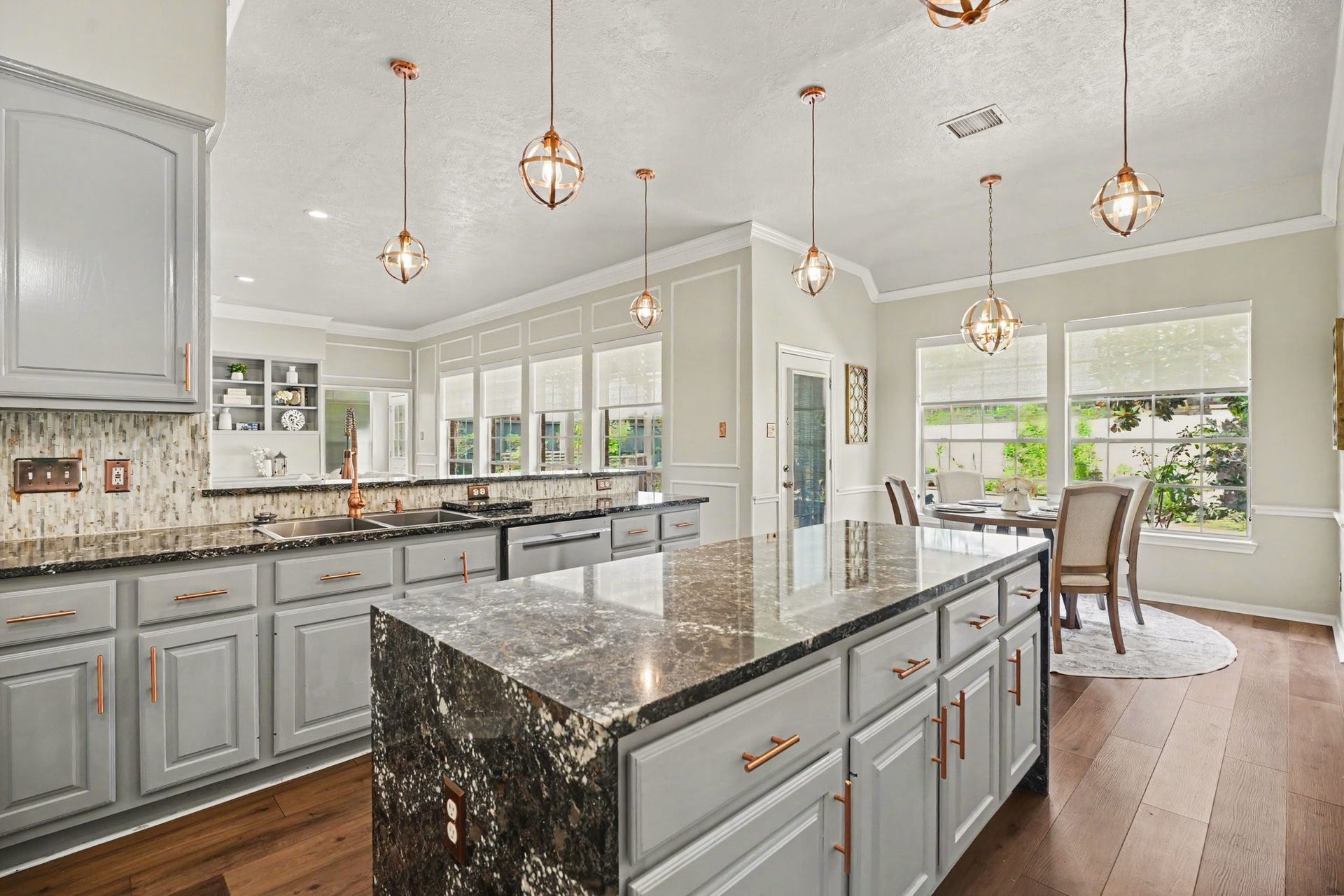 16507 Heather Meadow Court, Pasadena, TX 77059 The copper pendant lighting hangs perfectly over the kitchen island, creating an effortless flow that comfortably accommodates multiple cooks during gatherings or casual coffee and dessert with friends.