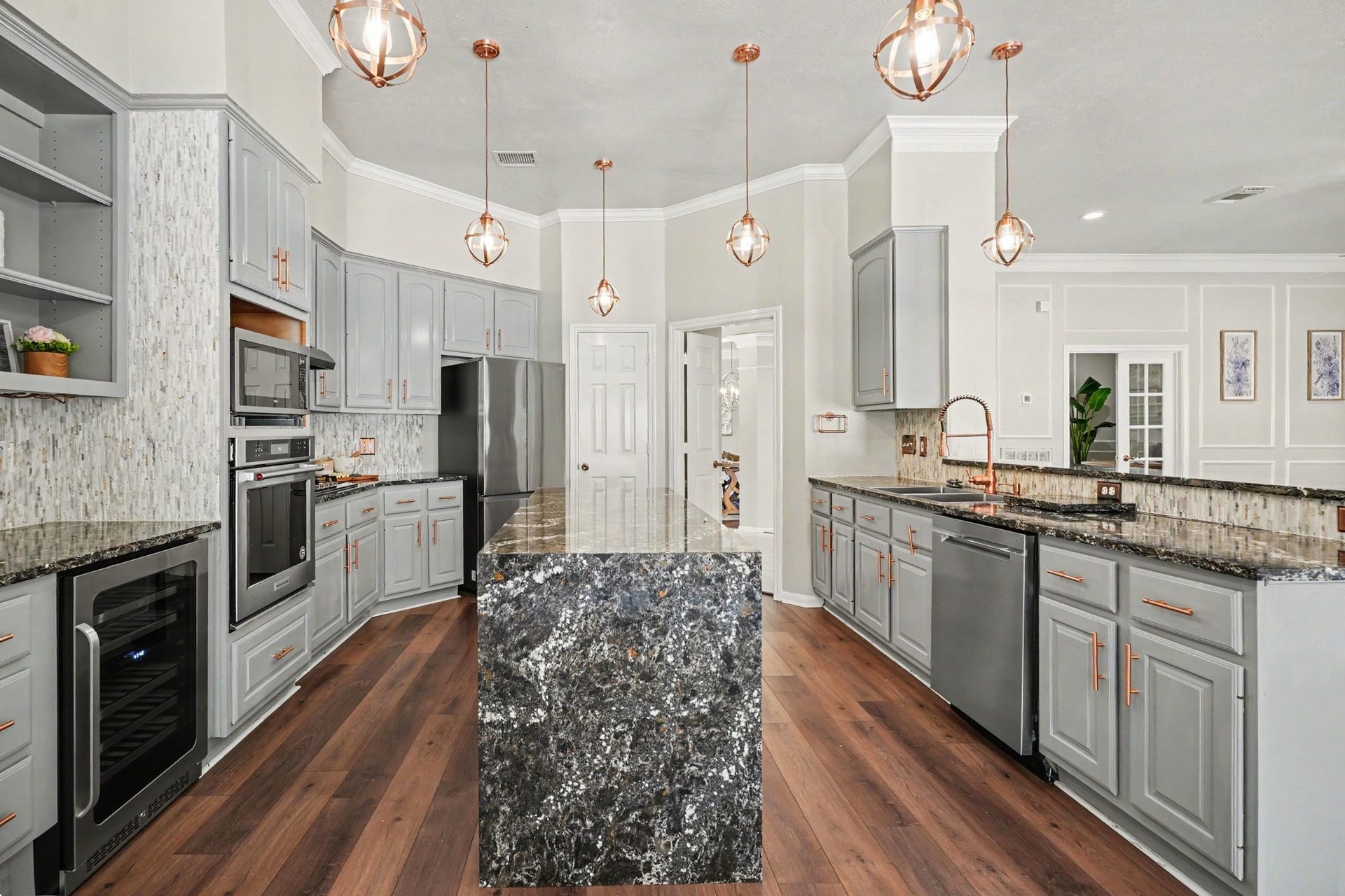 16507 Heather Meadow Court, Pasadena, TX 77059 The kitchen quartz countertops feature a stunning celestial-inspired design, with a deep, starry-night backdrop accented by countless sparkling flecks and a distinctive Orions Belt-like pattern. A unique, eye-catching finish that adds depth, character, and a touch of cosmic elegance to the kitchen.