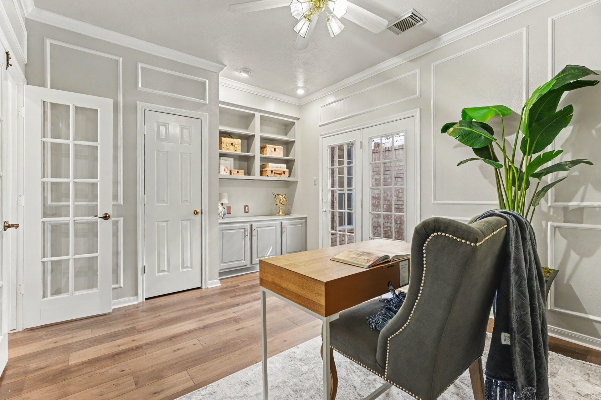 16507 Heather Meadow Court, Pasadena, TX 77059 This versatile home office features built-in shelving, custom cabinetry, and a dedicated closet, making it easily convertible into a fourth bedroom. The room is highlighted by elegant French doors that open onto a private, cozy atriumthe perfect serene setting for a tranquil water feature and lush tropical plants to enjoy while you work.