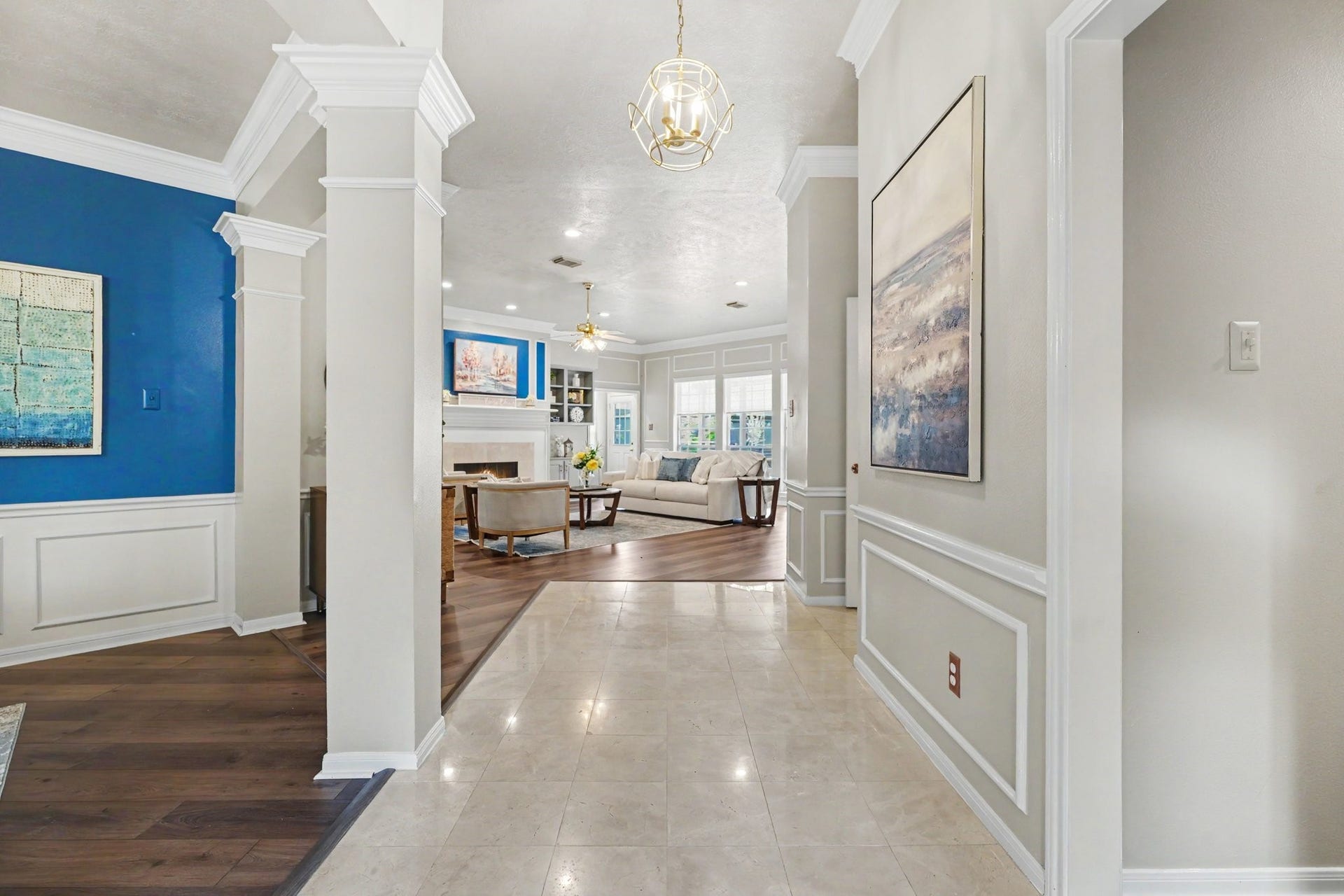 16507 Heather Meadow Court, Pasadena, TX 77059 The elegant marble-floored entryway creates a welcoming first impression, leading into the main living area. To the left, a formal dining room features a modern blue accent wall, while a separate home office offers a dedicated space for work or study.