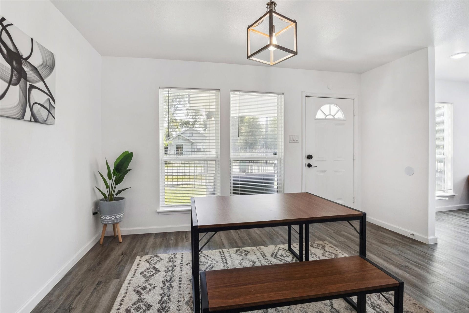The kitchen features extensive granite countertops, subway tile backsplash, and stainless steel appliances for a modern finish. An oversized island with bar seating for four opens to the dining area, creating the perfect flow for everyday living and entertaining.